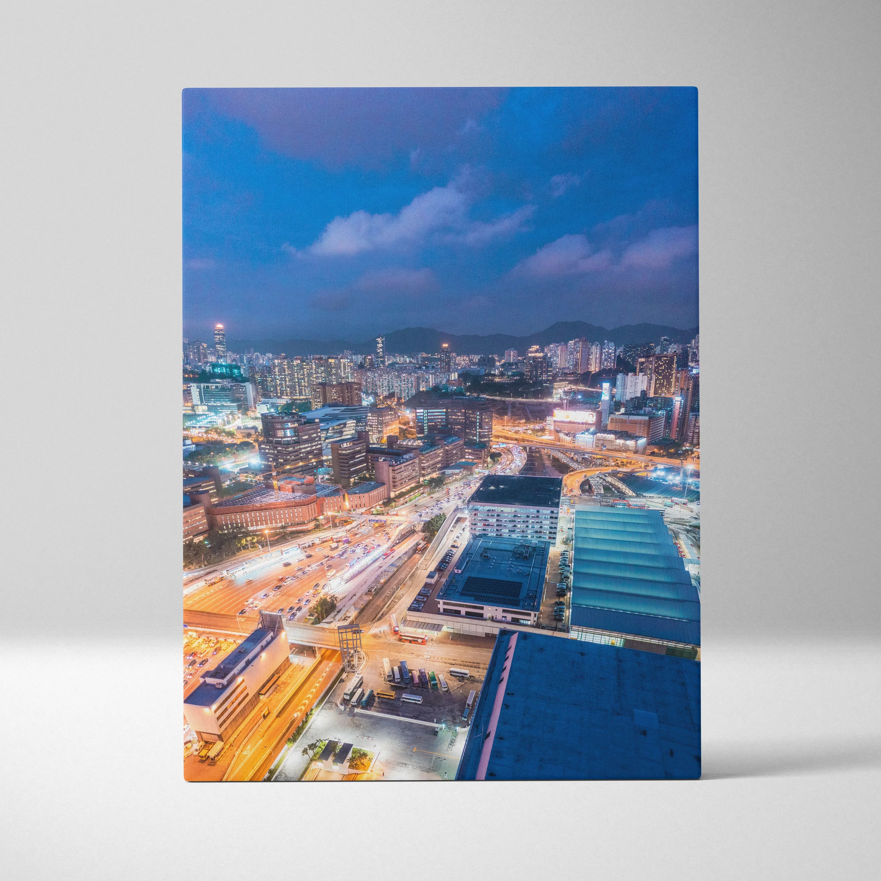 Vibrant modern cityscape canvas wall art featuring illuminated buildings and streets at dusk.