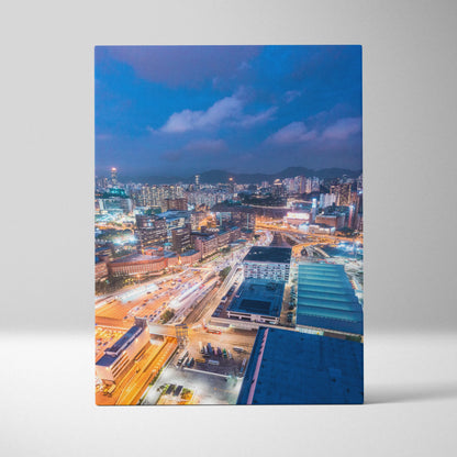 Vibrant modern cityscape canvas wall art featuring illuminated buildings and streets at dusk.