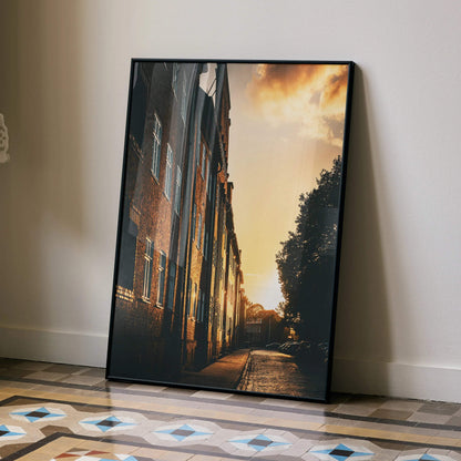 Vertical wall art poster of vibrant sunset cityscape with buildings and warm sky colors.