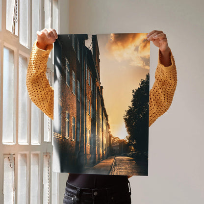 Vertical wall art poster featuring a vibrant sunset cityscape with illuminated buildings and a glowing sky.