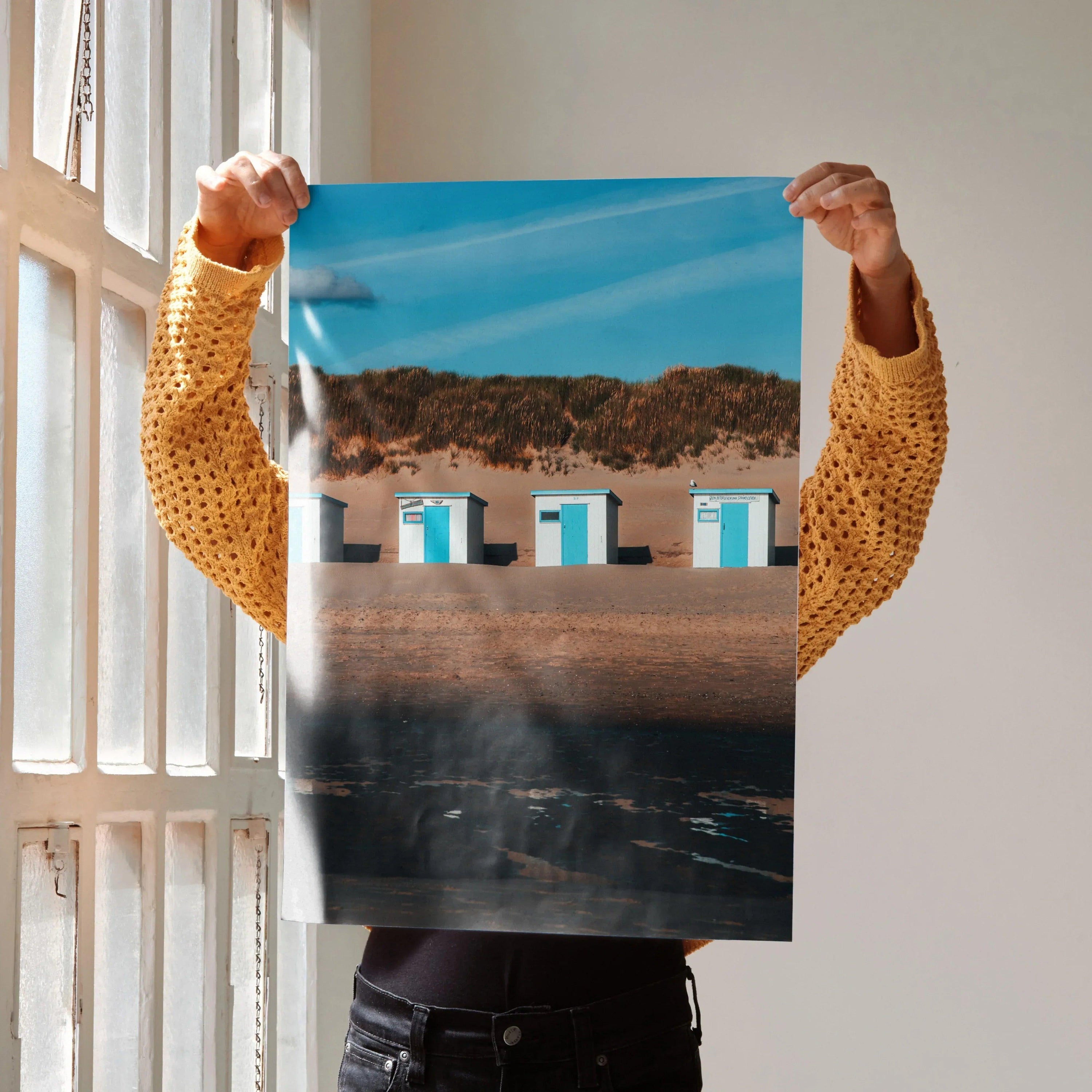 Serene beach landscape poster with blue sky, sand dunes, and white cabins, vertical wall art.