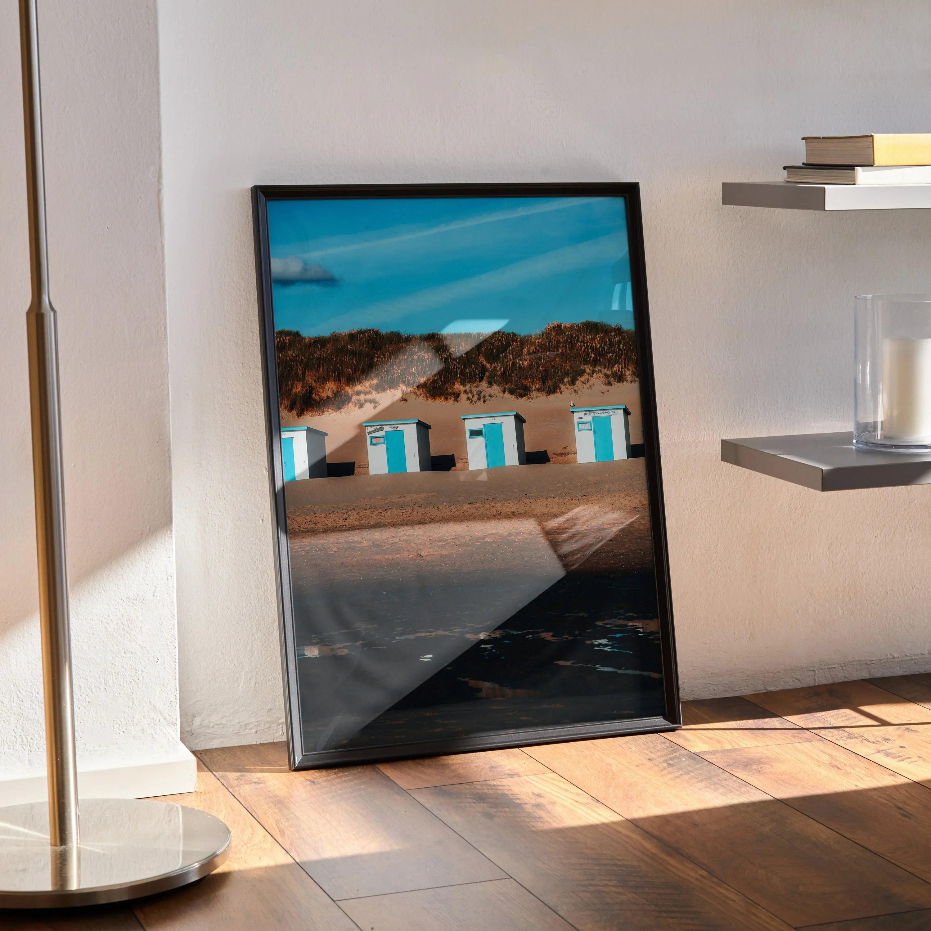 Serene beach landscape wall art poster with sand dunes and blue sky in black frame.