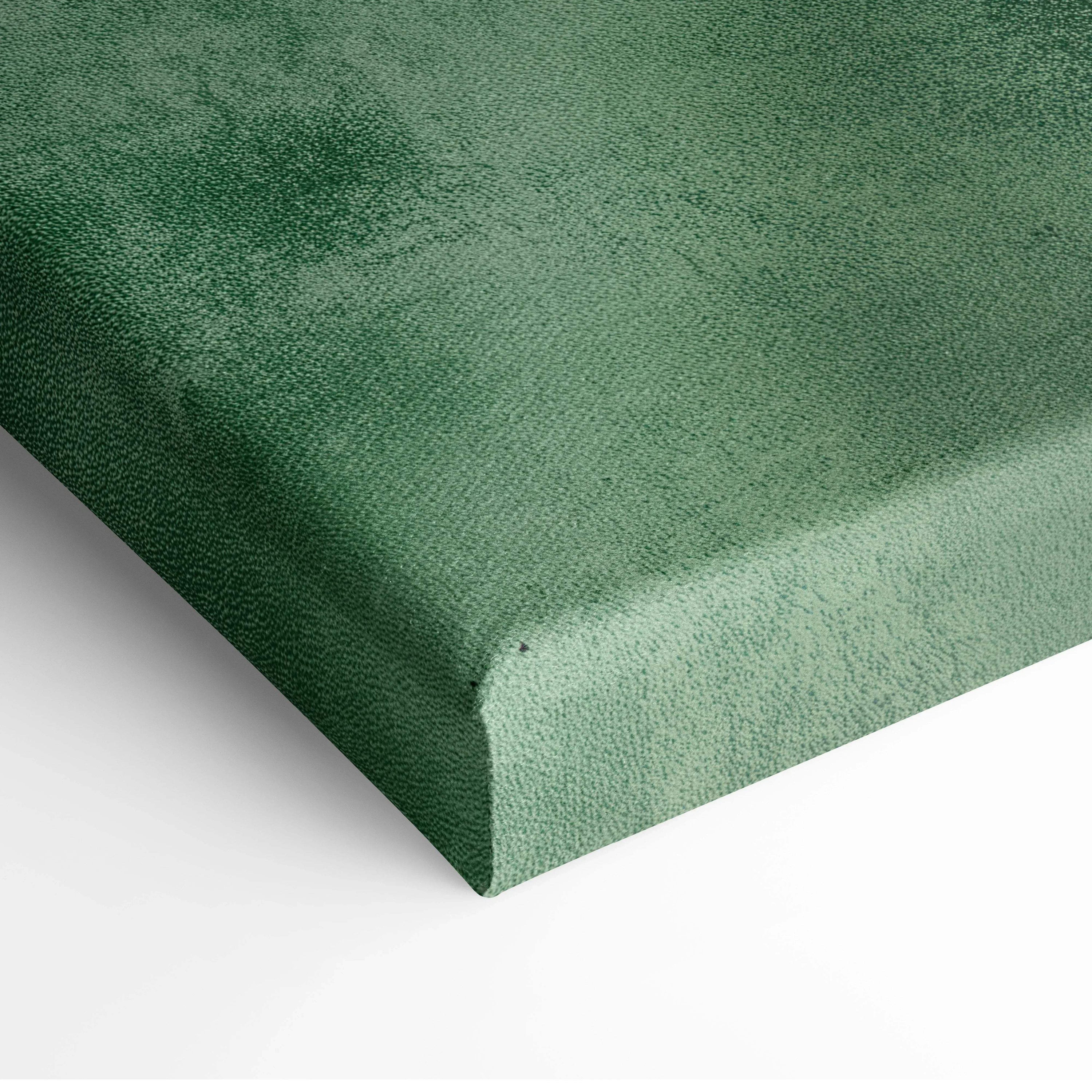 Close-up of green textured canvas corner of vertical wall art print with subtle painted details.
