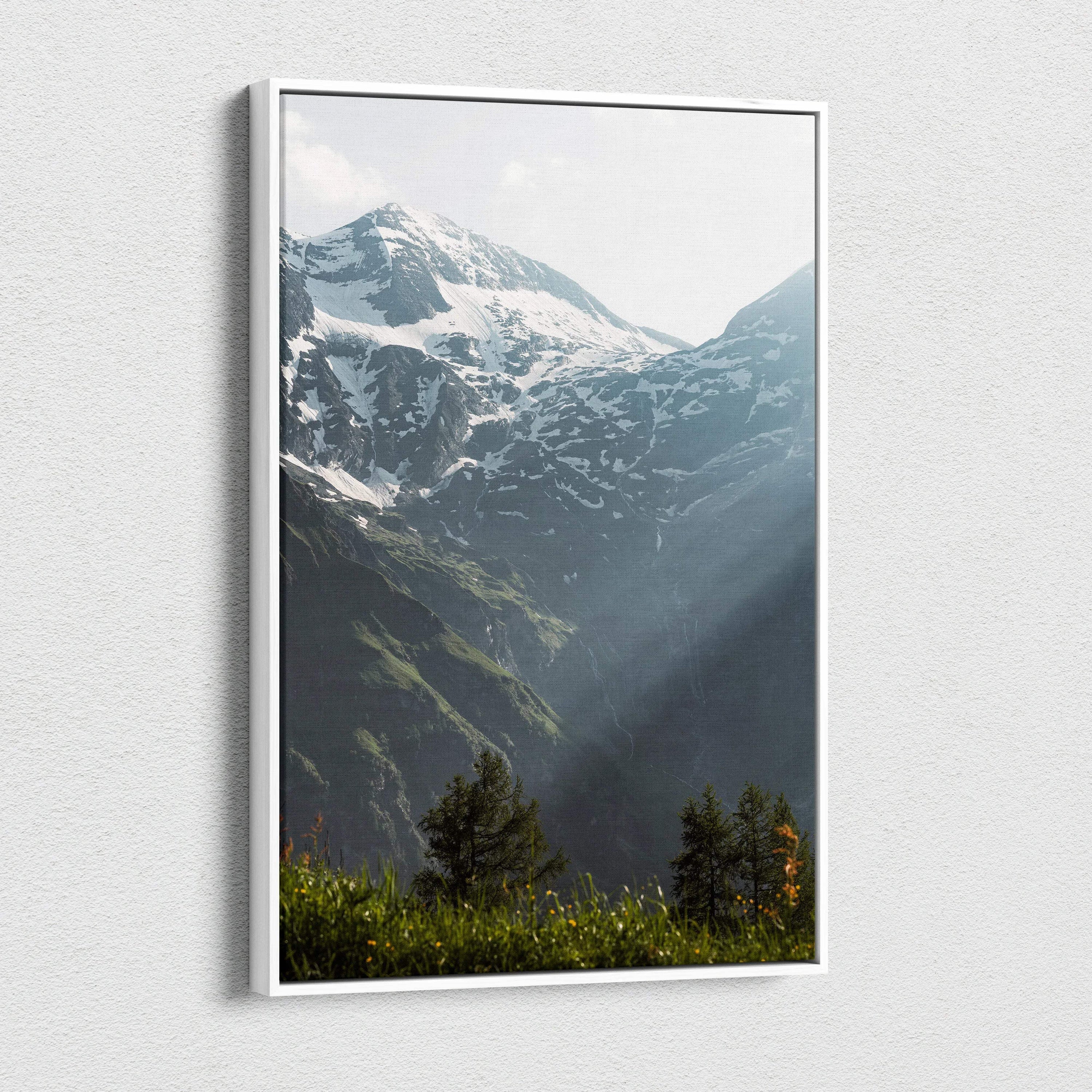 Snowy mountain peaks with sunlight rays on vertical canvas wall art.