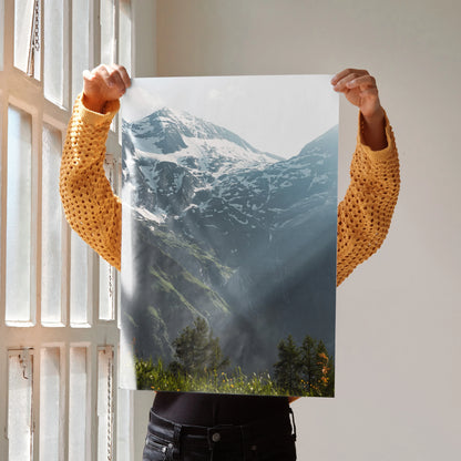 Vertical wall art poster featuring snow-capped mountains with sunlight rays and green forest foreground.