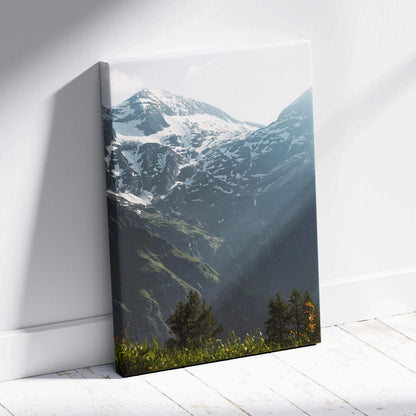 Snowy mountain landscape canvas wall art with sunlight and forest foreground.