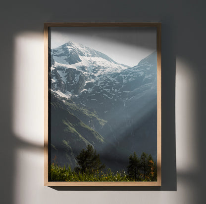 Vertical wall art poster featuring snow-capped mountains with sunlight and green forest foreground.