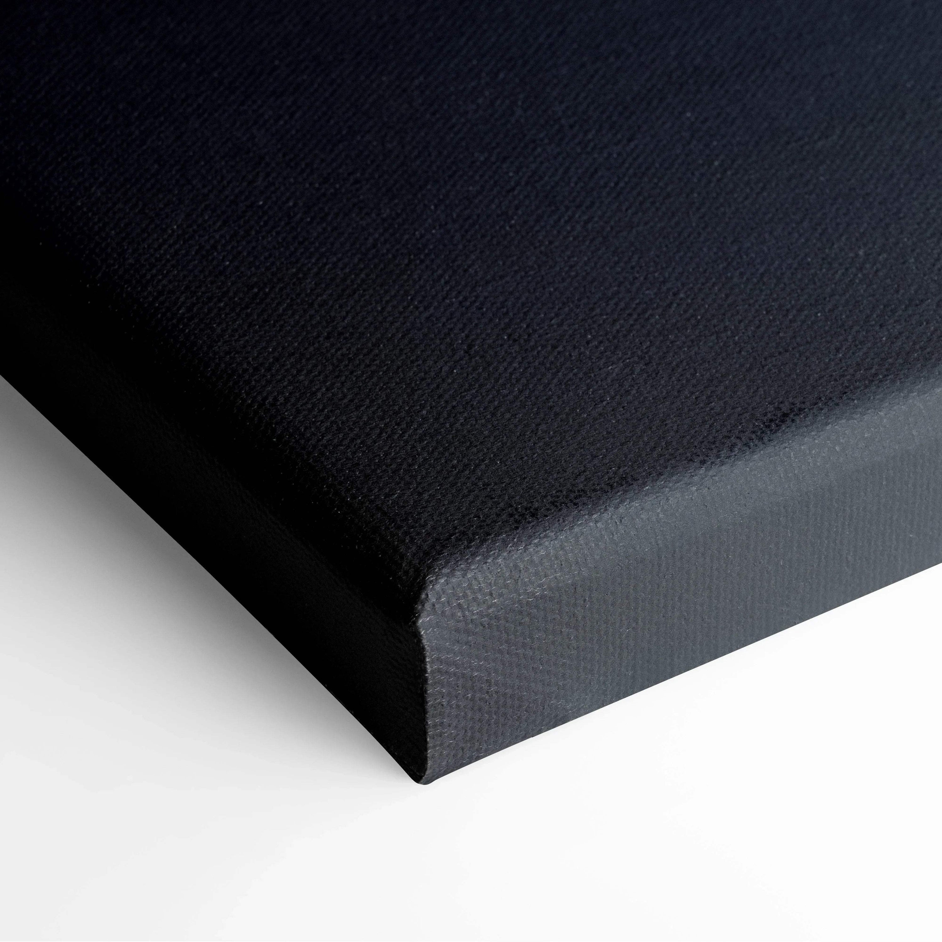 Black wrapped canvas corner of wall art with textured surface.