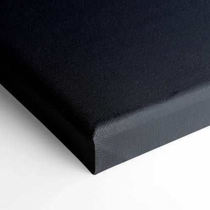 Black wrapped canvas corner of wall art with textured surface.