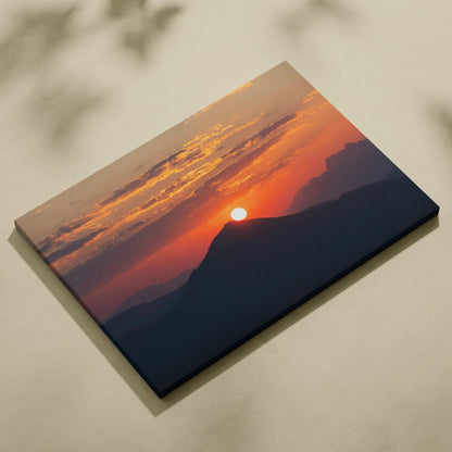 Canvas wall art featuring a vibrant mountain sunset with glowing orange and red sky hues.