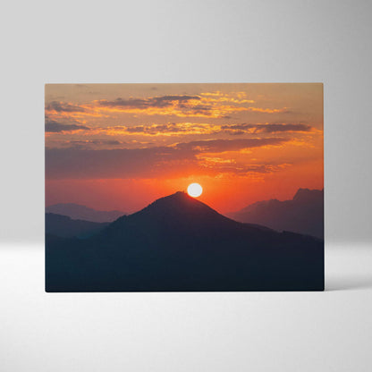 Canvas wall art featuring a vibrant mountain sunset with orange and purple sky hues.