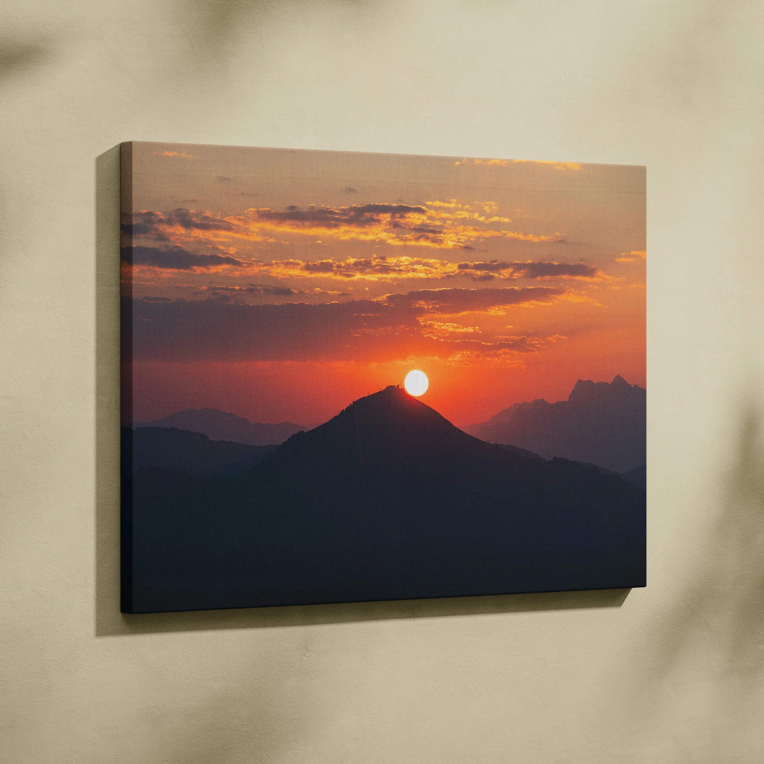 Sunset over mountain silhouette with vibrant orange sky on canvas wall art print.