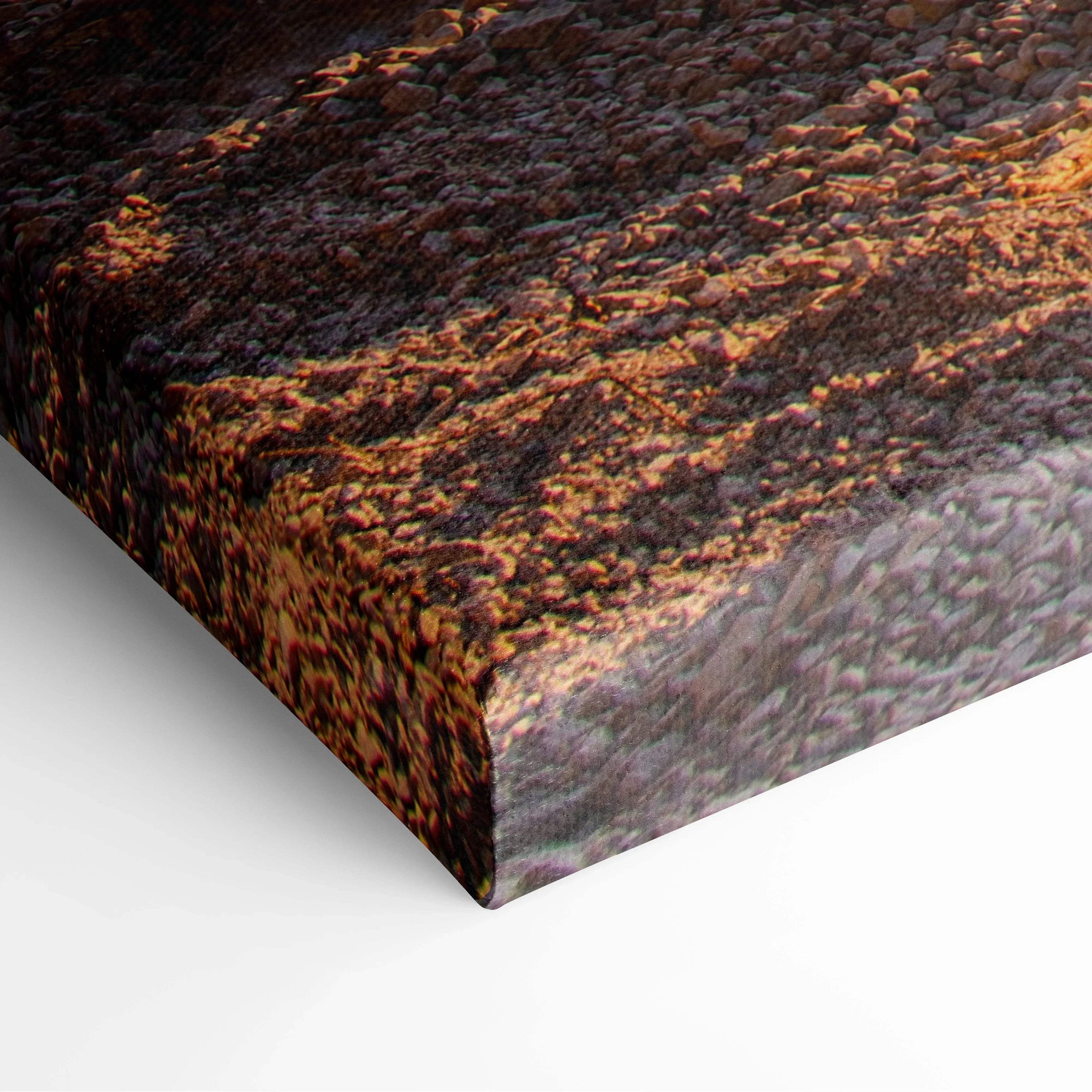 Close-up of canvas wall art showing textured mountain and sunset colors on wrapped edges.