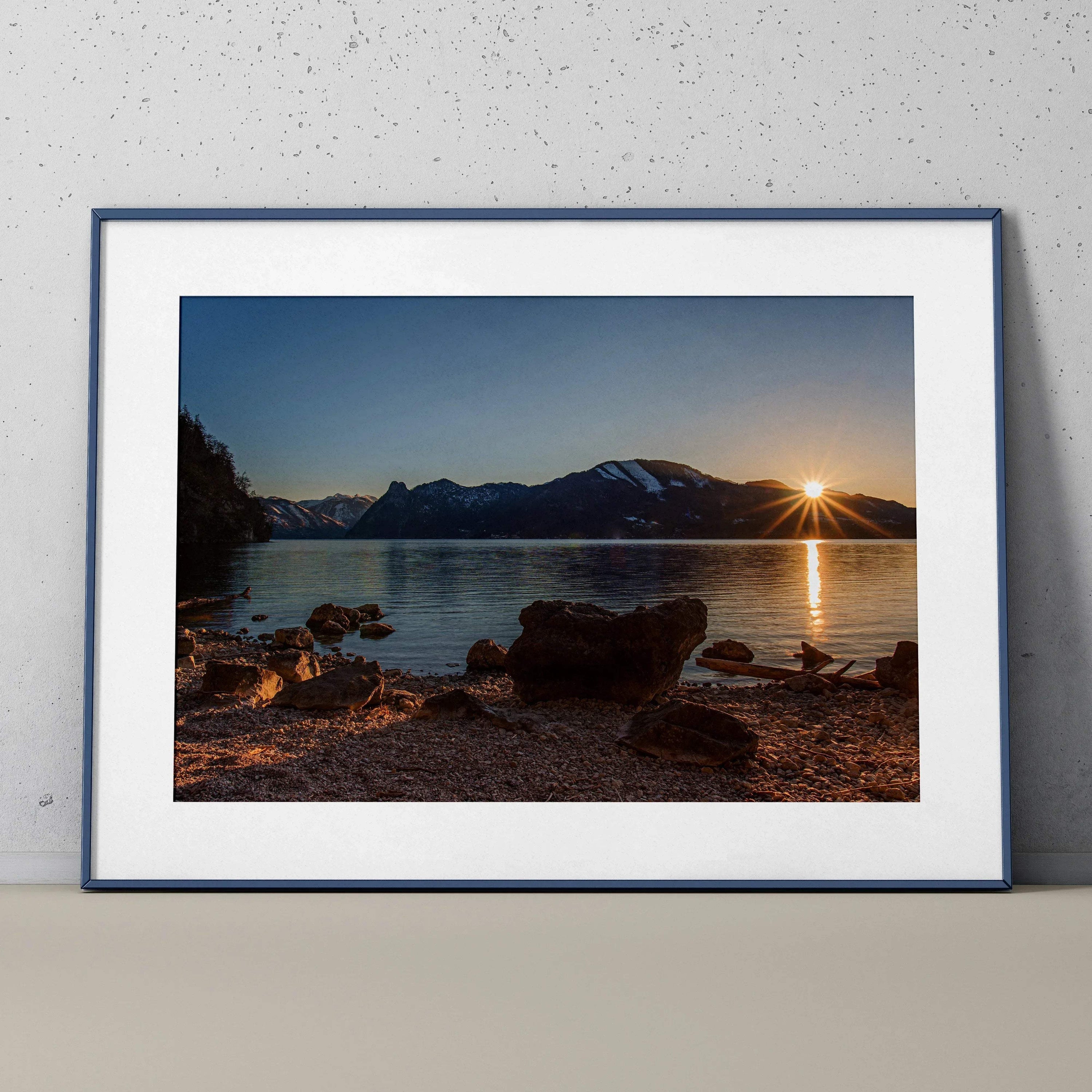 Majestic mountain sunset over calm lake with rocky shore, framed wall art poster.