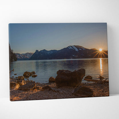 Mountain sunset reflected on calm lake with rocky shore, canvas wall art print.