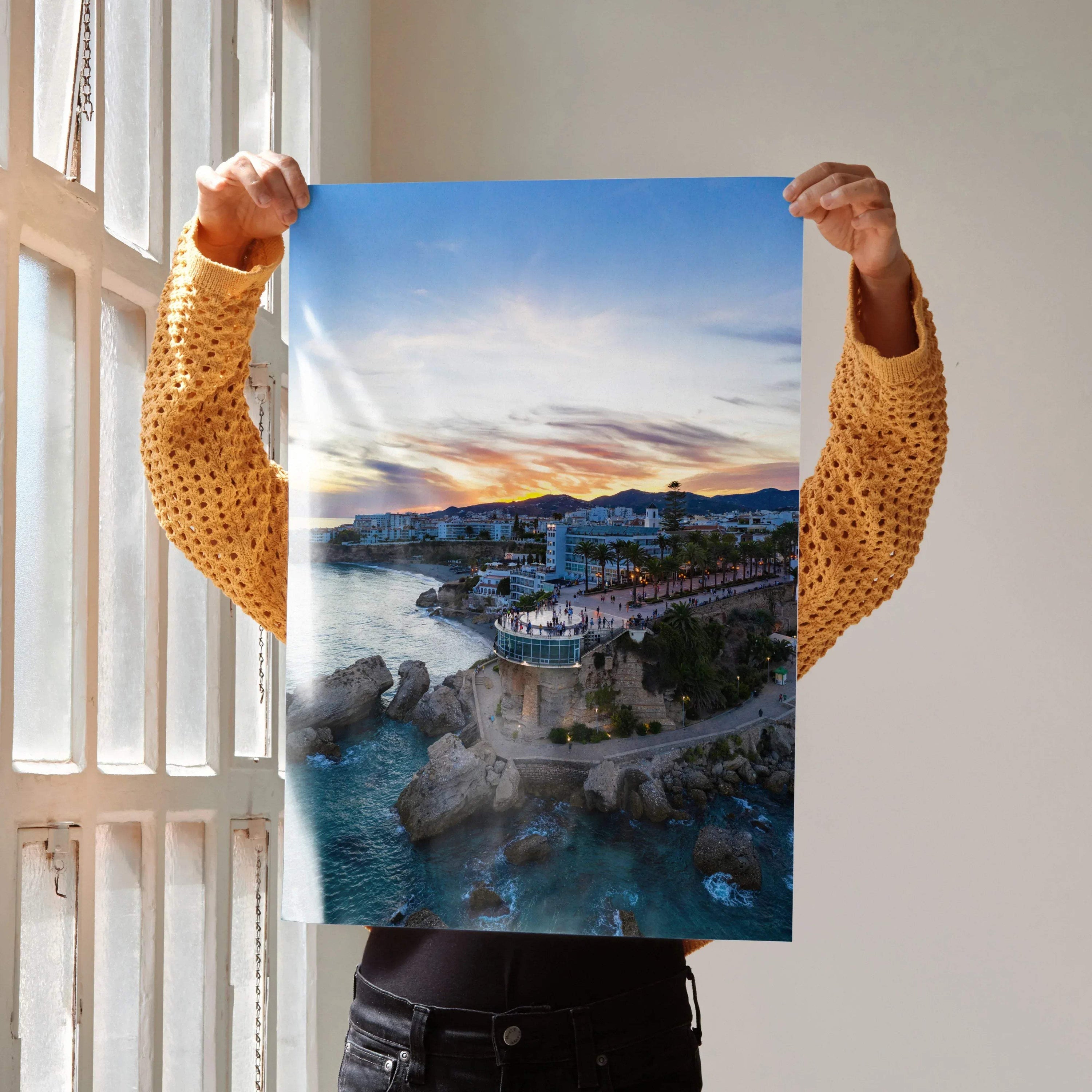 Vertical vibrant city sunset poster showing coastal buildings and rocky shore as wall art.