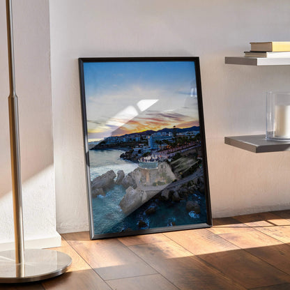 Vertical city skyline sunset wall art poster with vibrant orange and blue hues in a black frame.