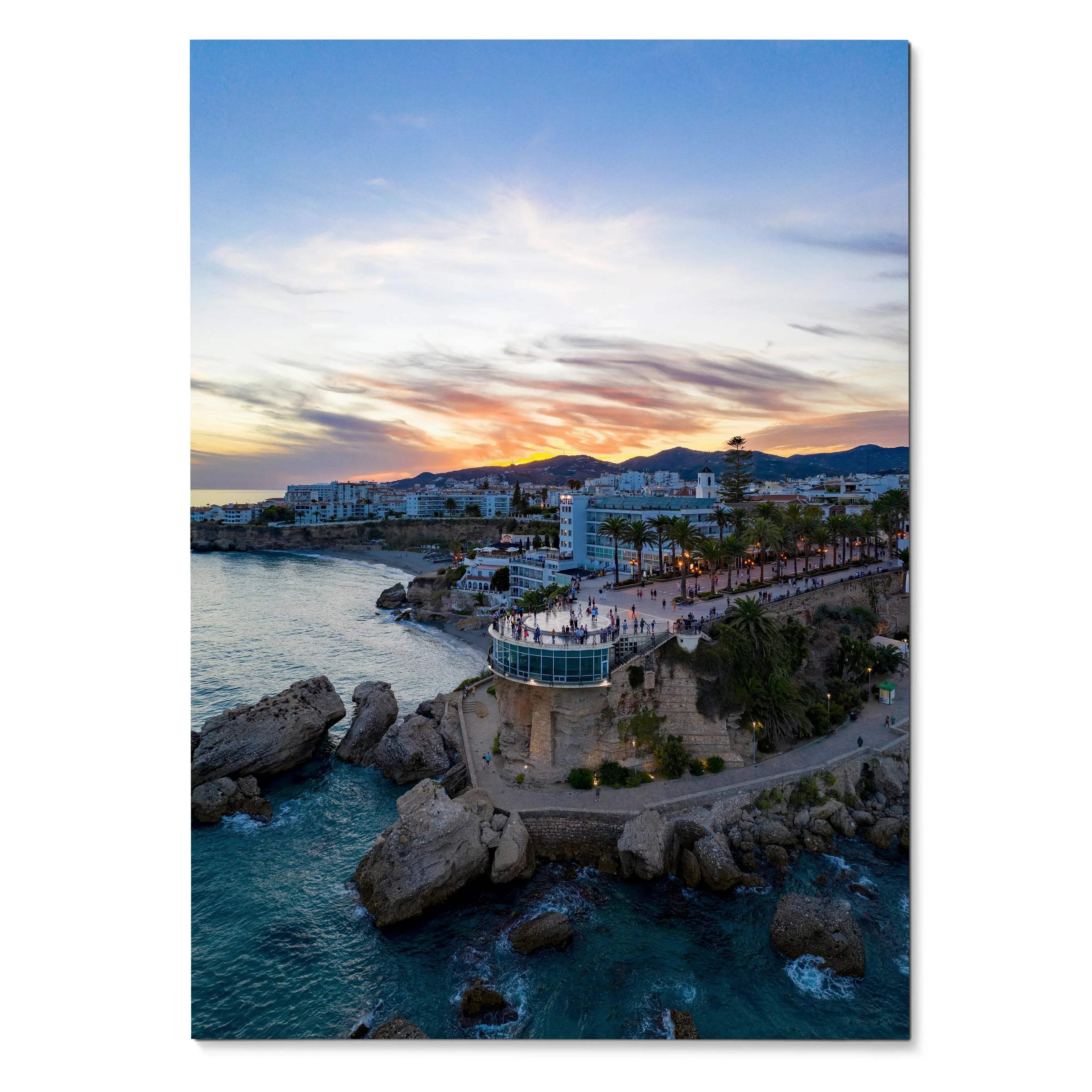 Vertical cityscape wall art poster showing sunset sky over coastal cliffs and buildings.
