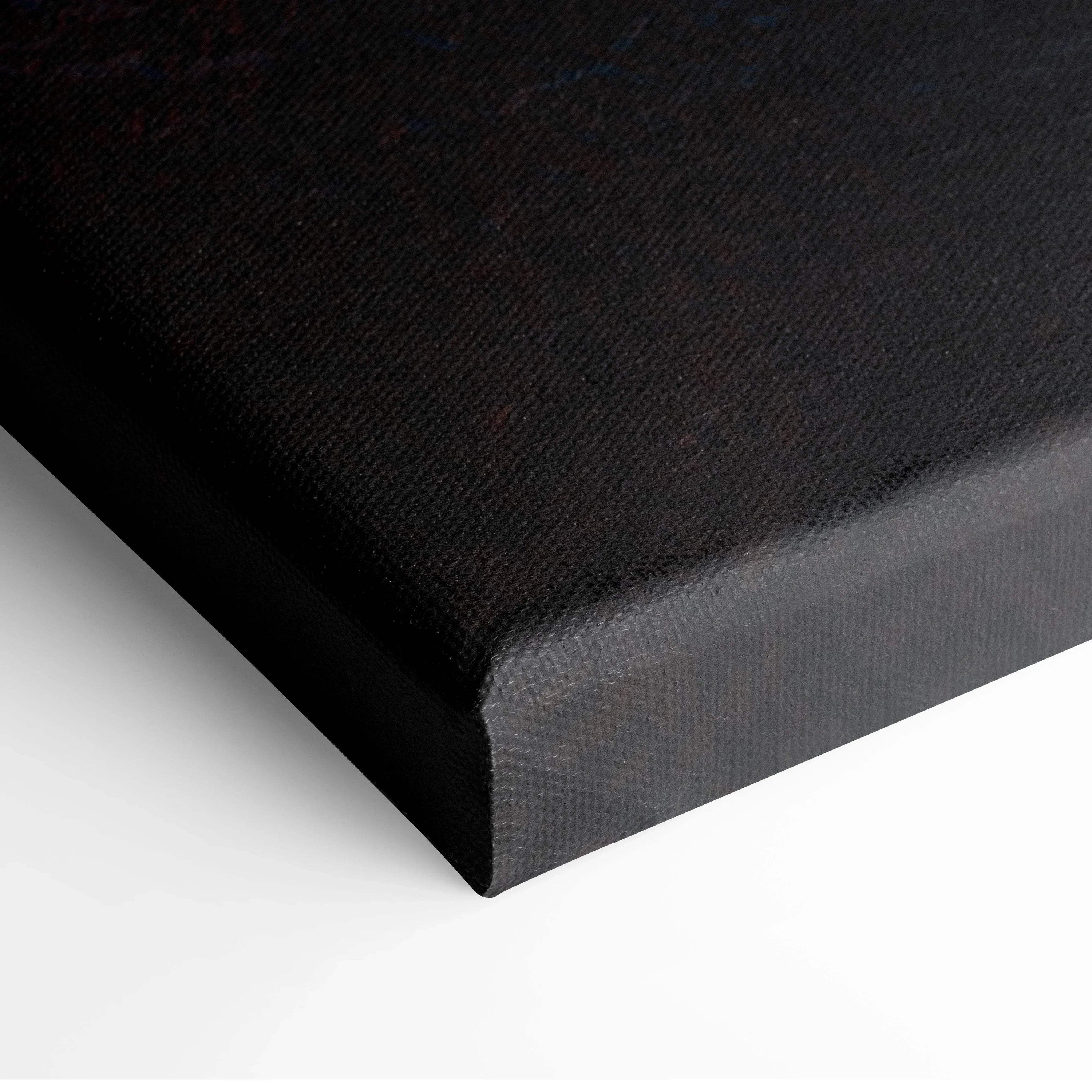 Black edge of stretched canvas wall art with textured fabric surface.