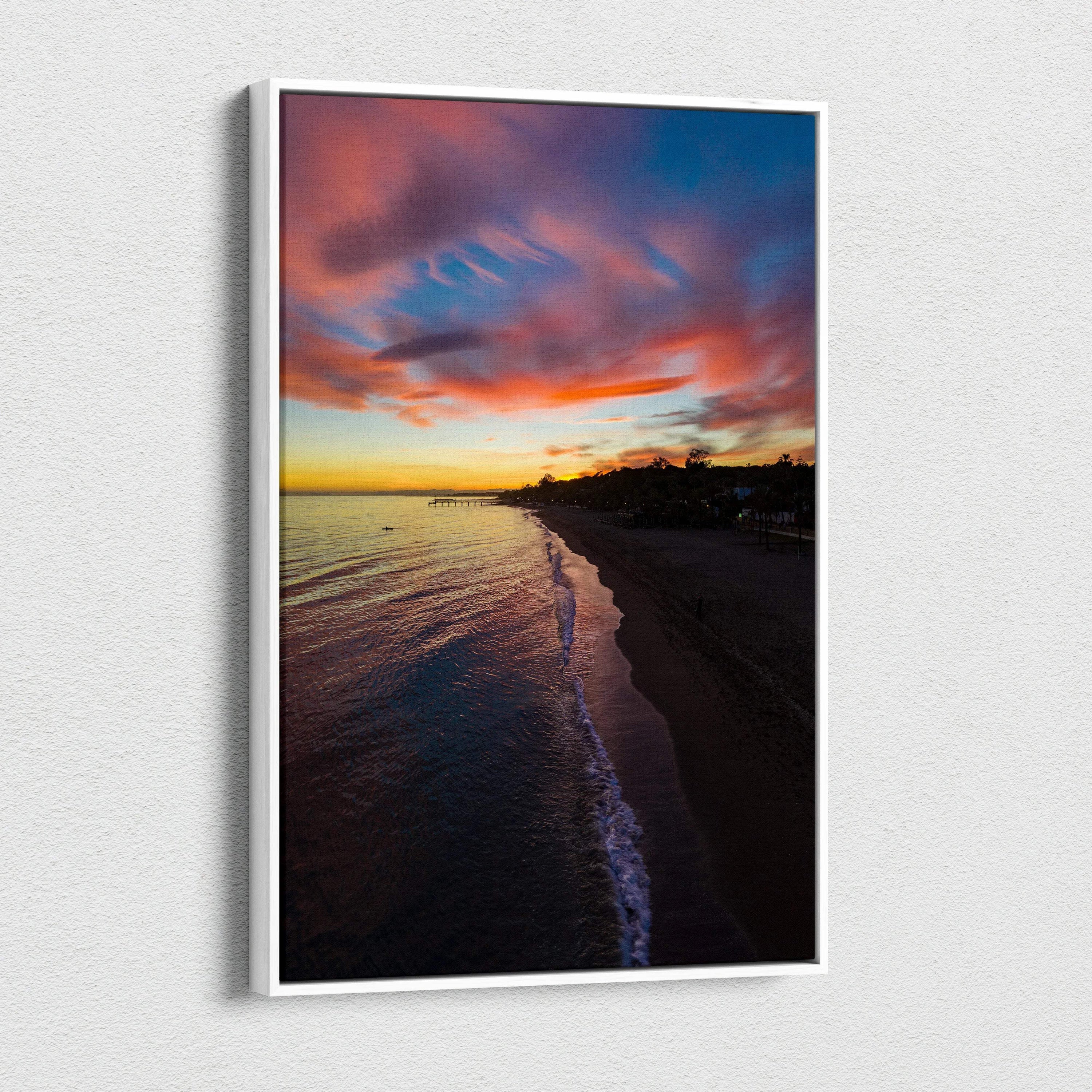 Vibrant beach sunset canvas wall art with colorful sky and calm ocean waves at dusk.