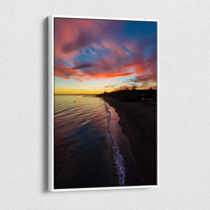 Vibrant beach sunset canvas wall art with colorful sky and calm ocean waves at dusk.