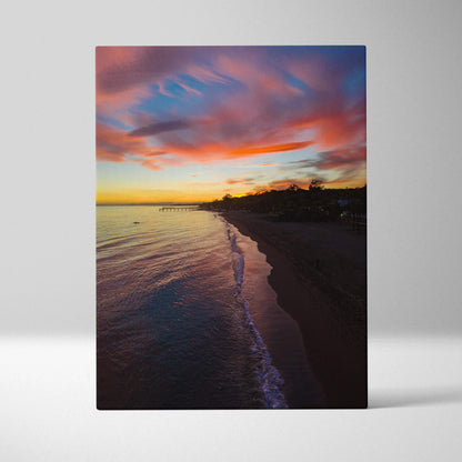 Vibrant beach sunset canvas wall art featuring colorful sky and calm shoreline.