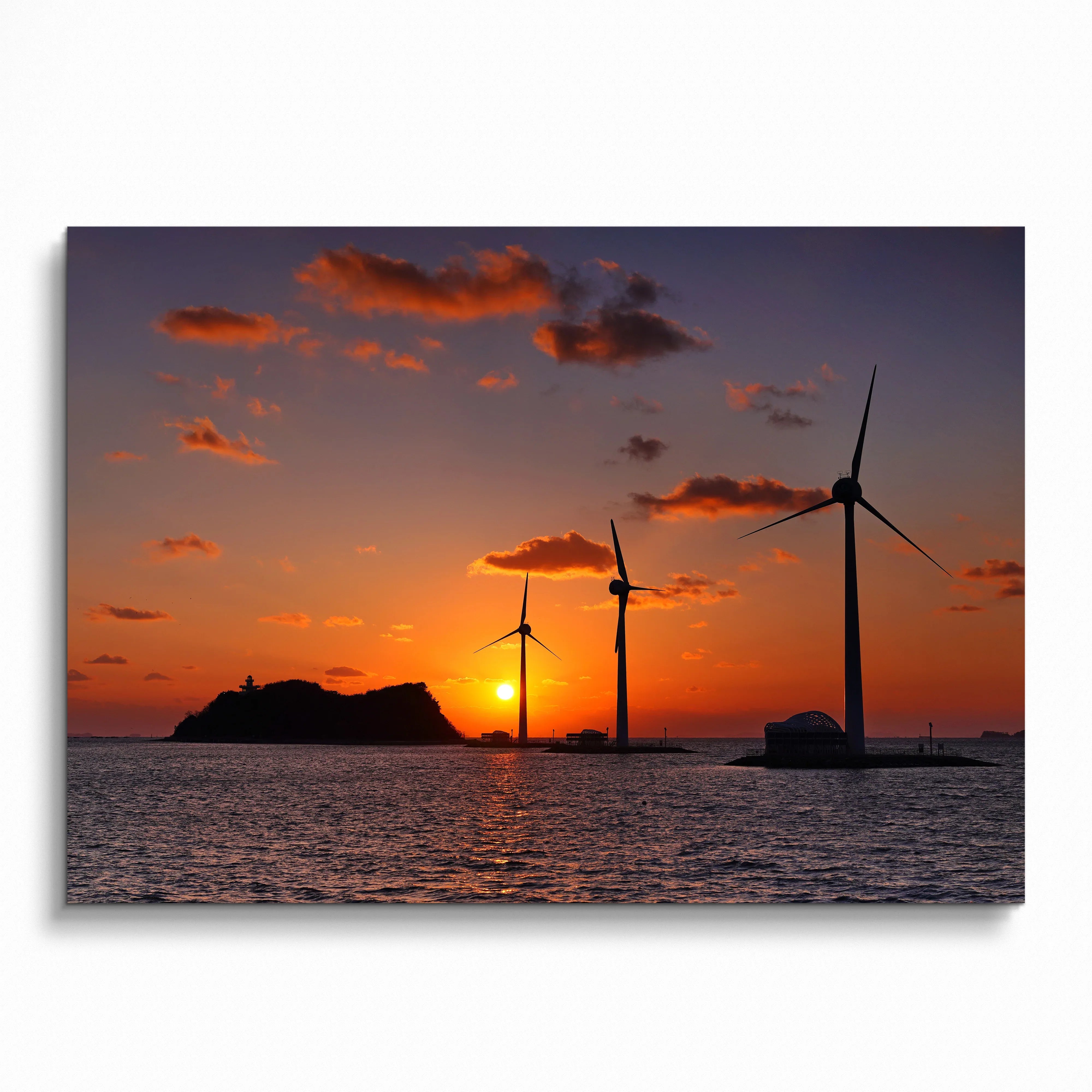 Ocean sunset with vibrant orange sky and wind turbines over water poster wall art.