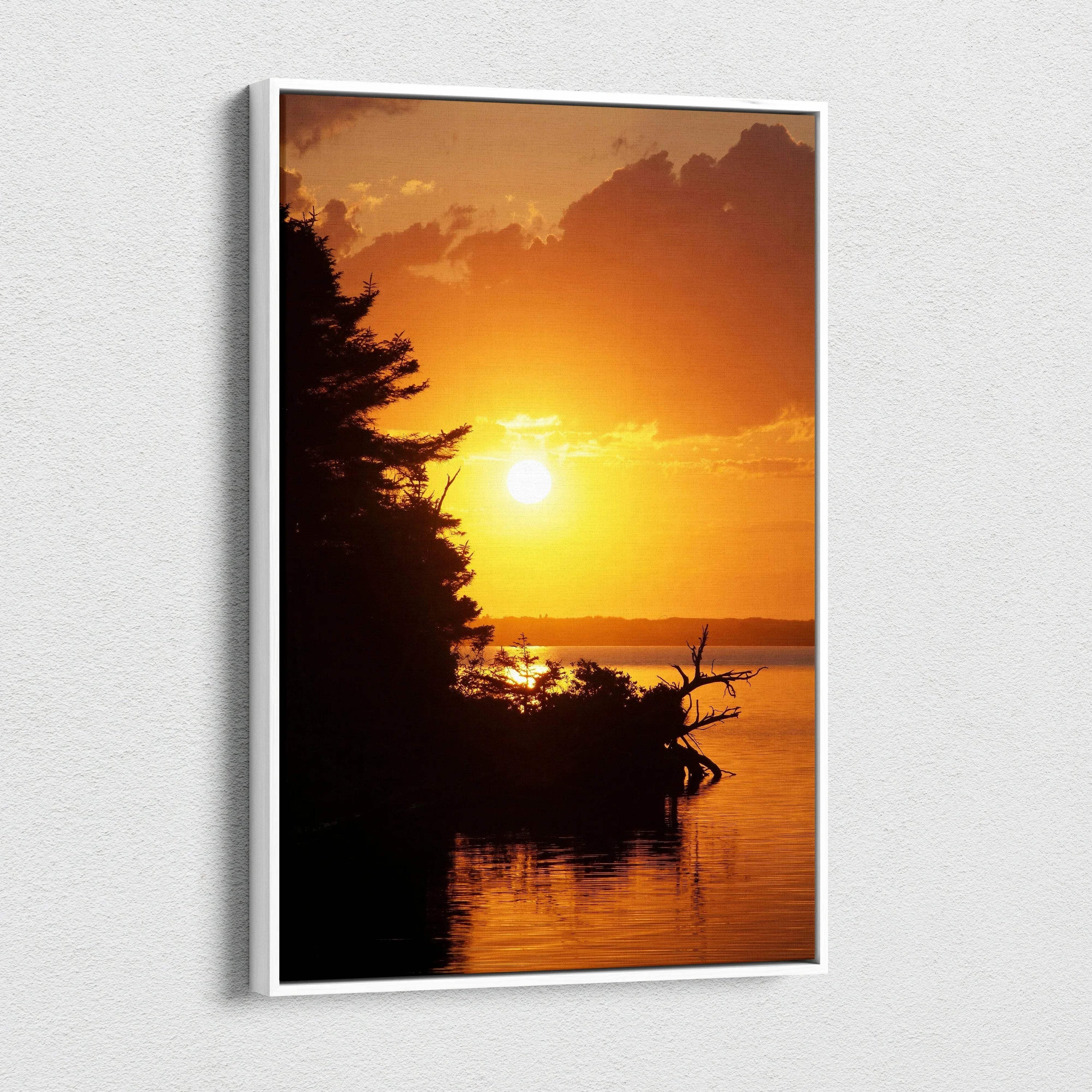 Vertical canvas wall art featuring a vibrant orange beach sunset with silhouetted trees and calm water.