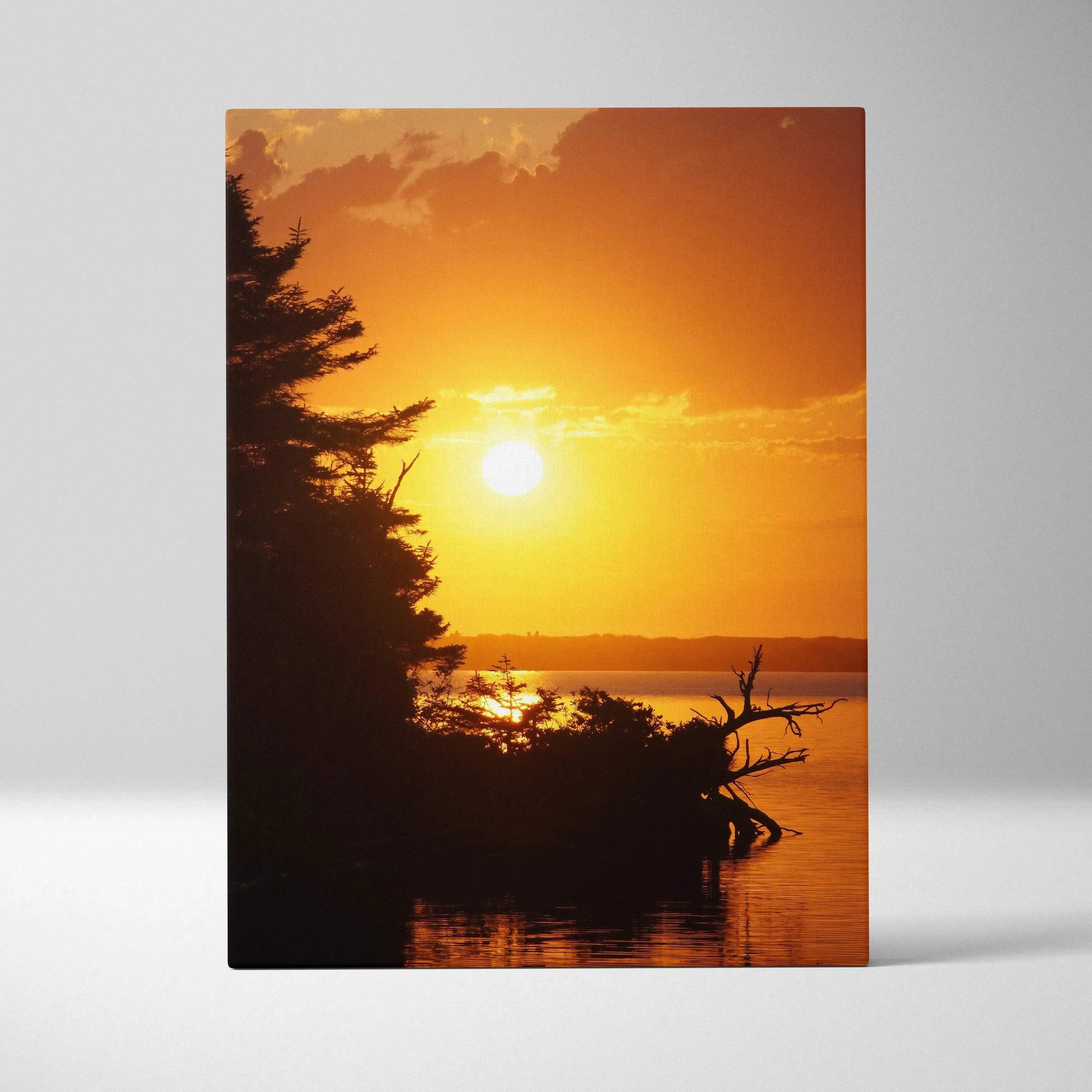 Canvas wall art of a vibrant beach sunset with silhouetted trees and glowing orange sky.