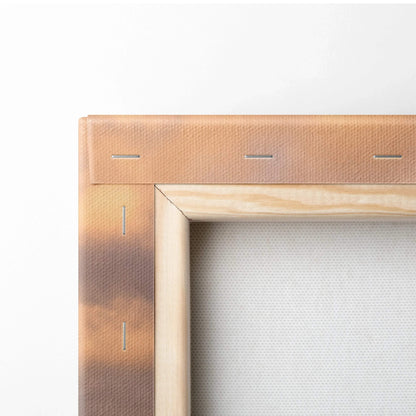 Close-up of wooden frame and canvas edge showing brown mountain sunset art on wall art canvas.