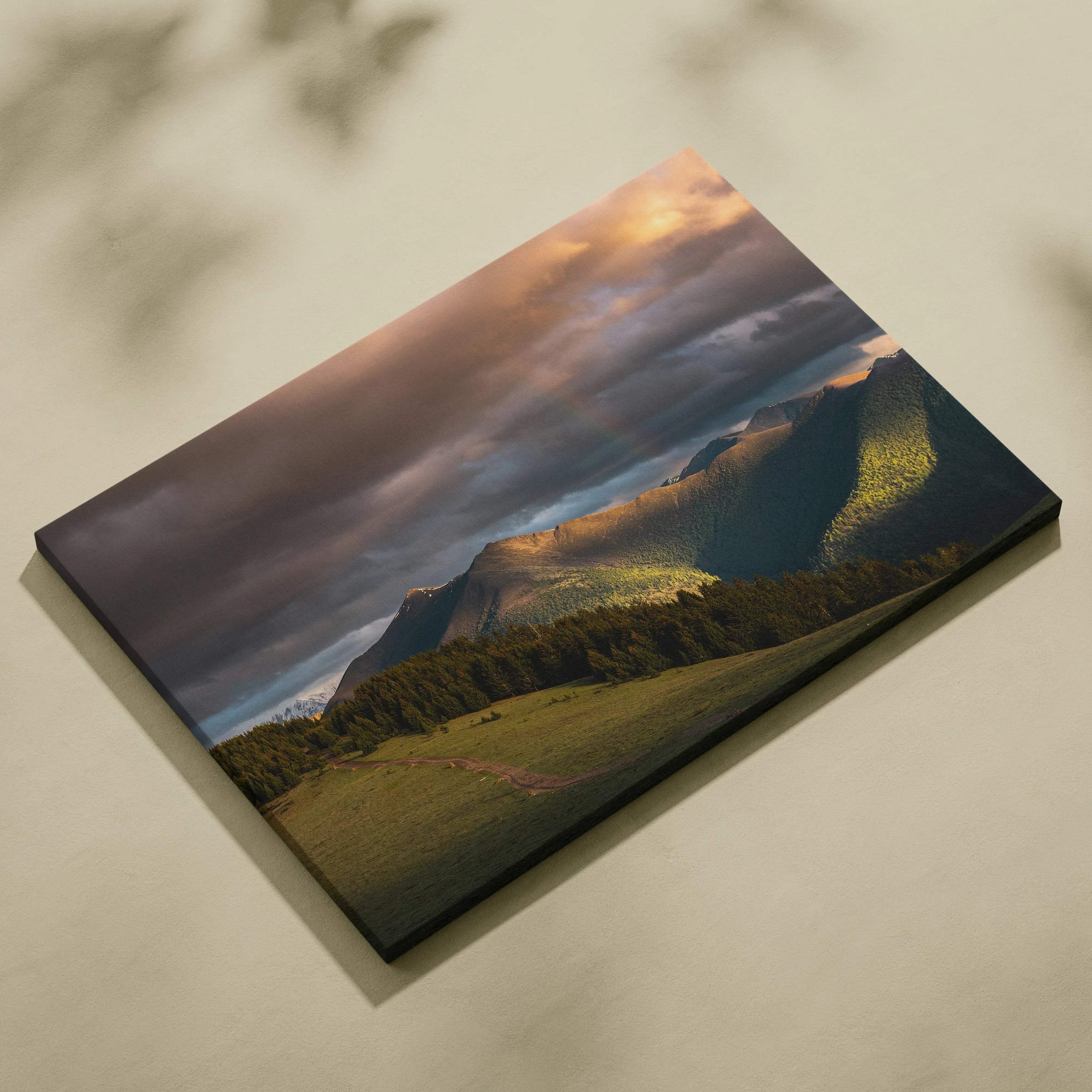 Canvas wall art featuring a dramatic mountain landscape at sunset with vibrant clouds and warm light.