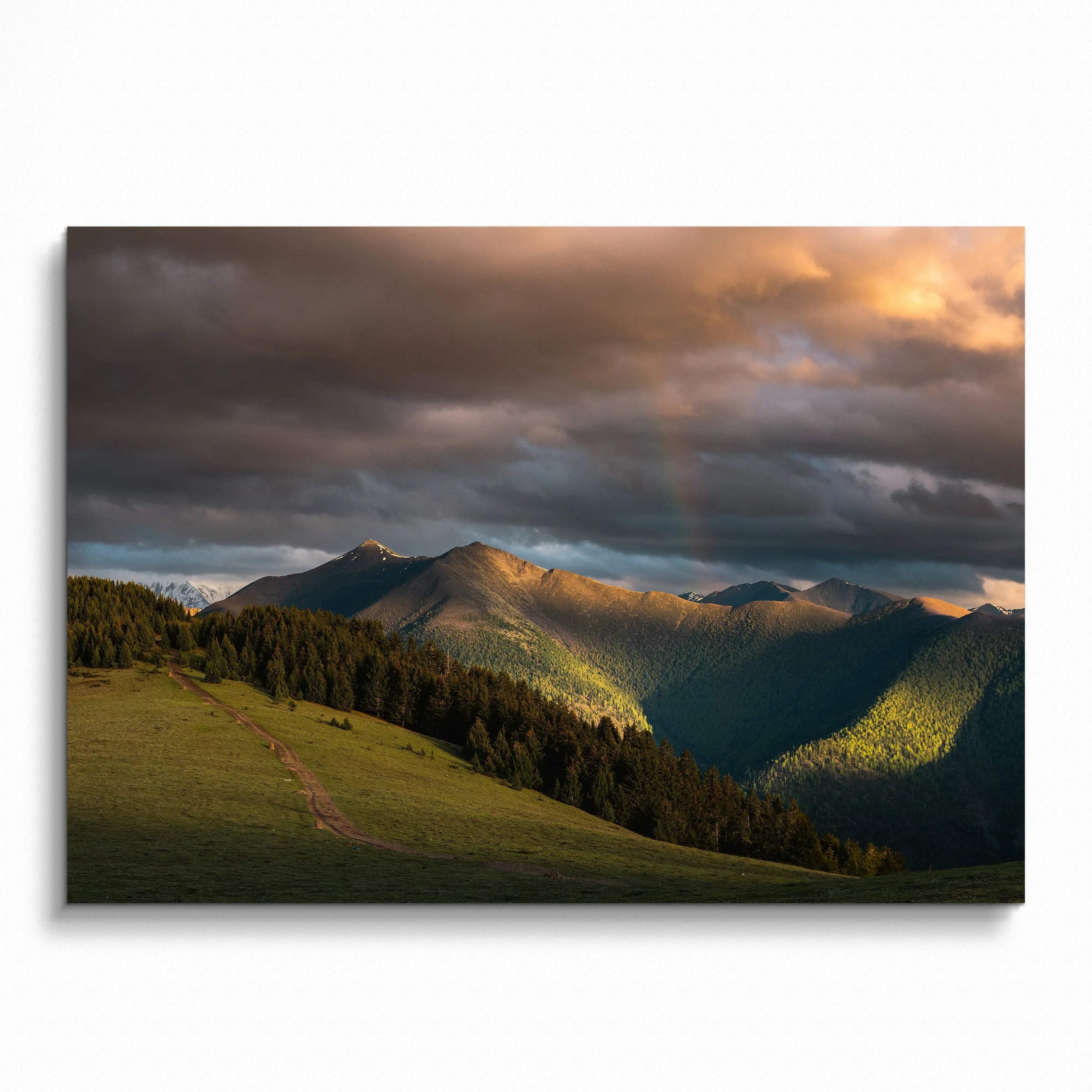 Majestic mountains under dramatic sunset sky with warm light and shadows wall art poster.