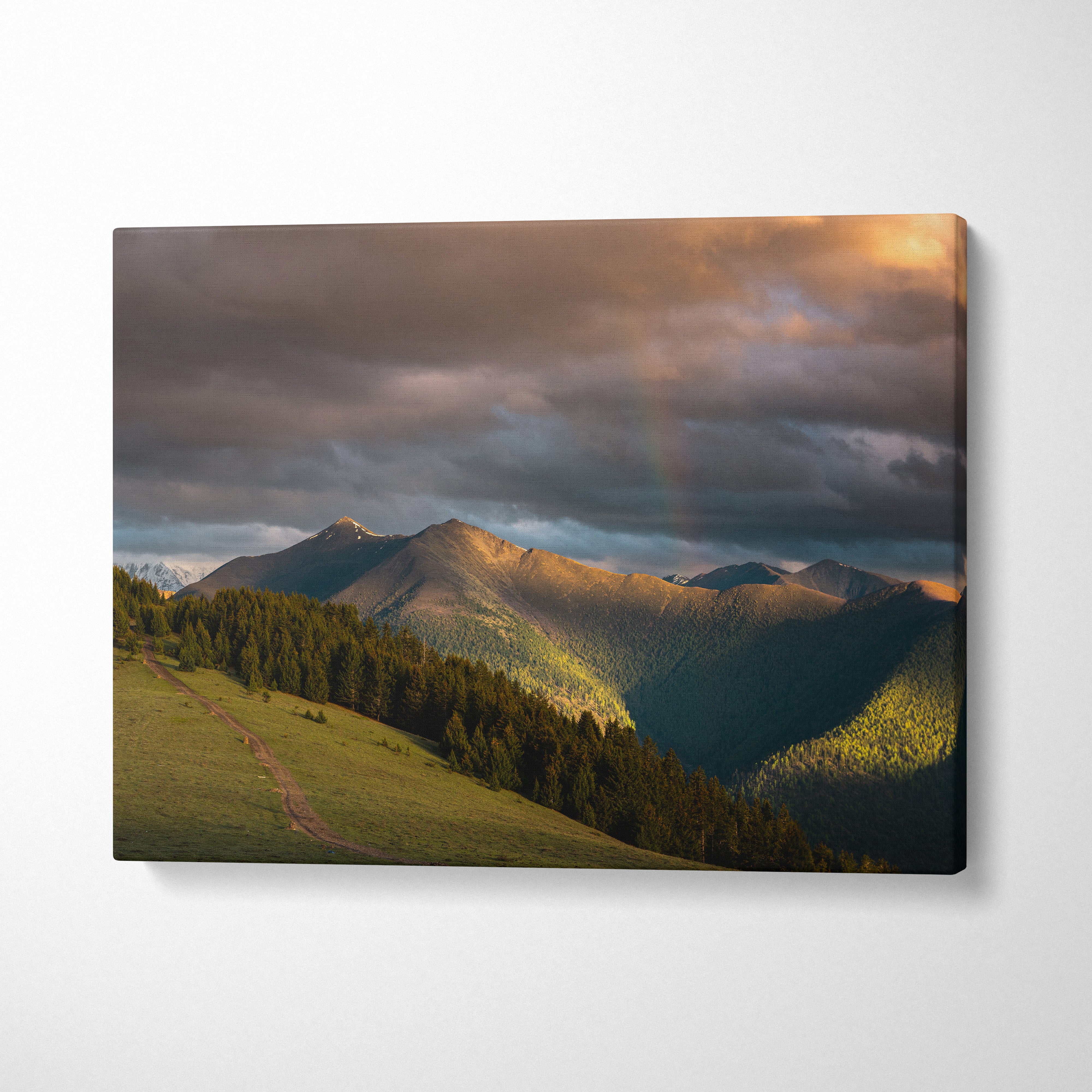 Canvas wall art featuring a mountain landscape at sunset with dramatic clouds and soft sunlight.