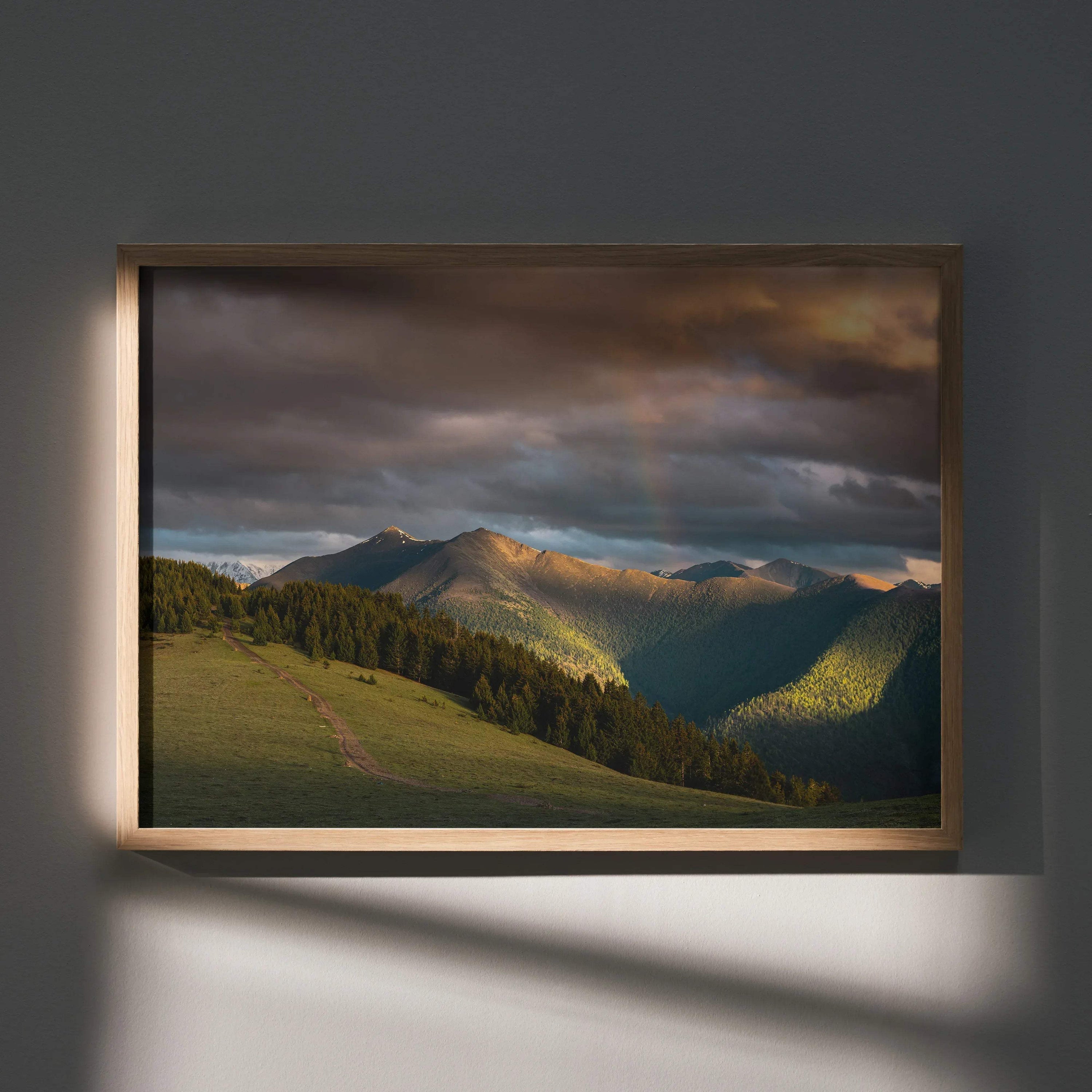Majestic mountains sunset wall art poster with dramatic clouds and sunlit peaks in wooden frame.