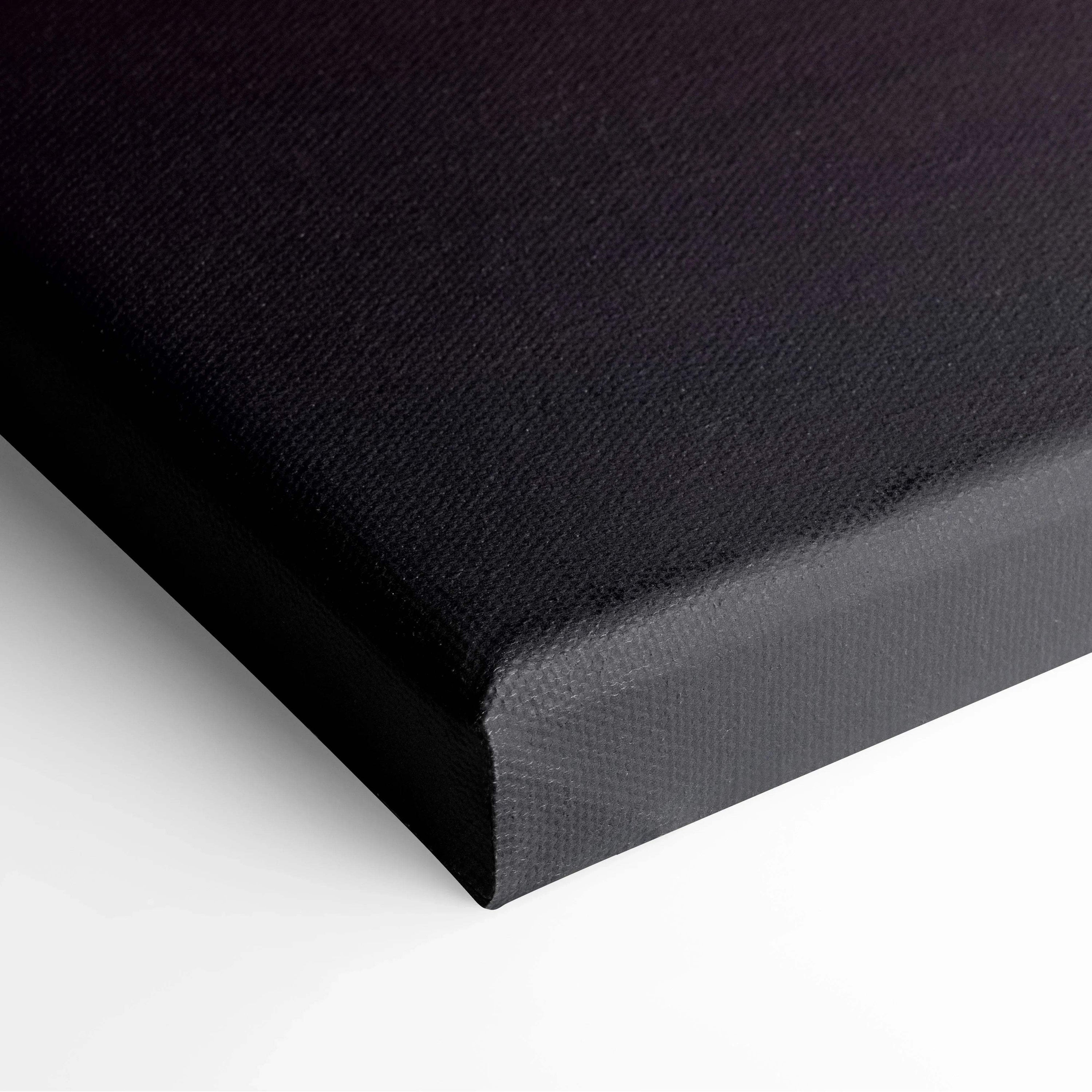 Black wrapped canvas edge of wall art with textured fabric surface.