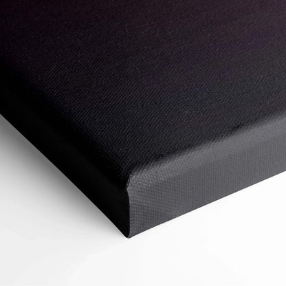 Black wrapped canvas edge of wall art with textured fabric surface.
