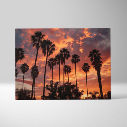 Canvas art featuring tall palm tree silhouettes against a vibrant orange and purple tropical sunset sky.