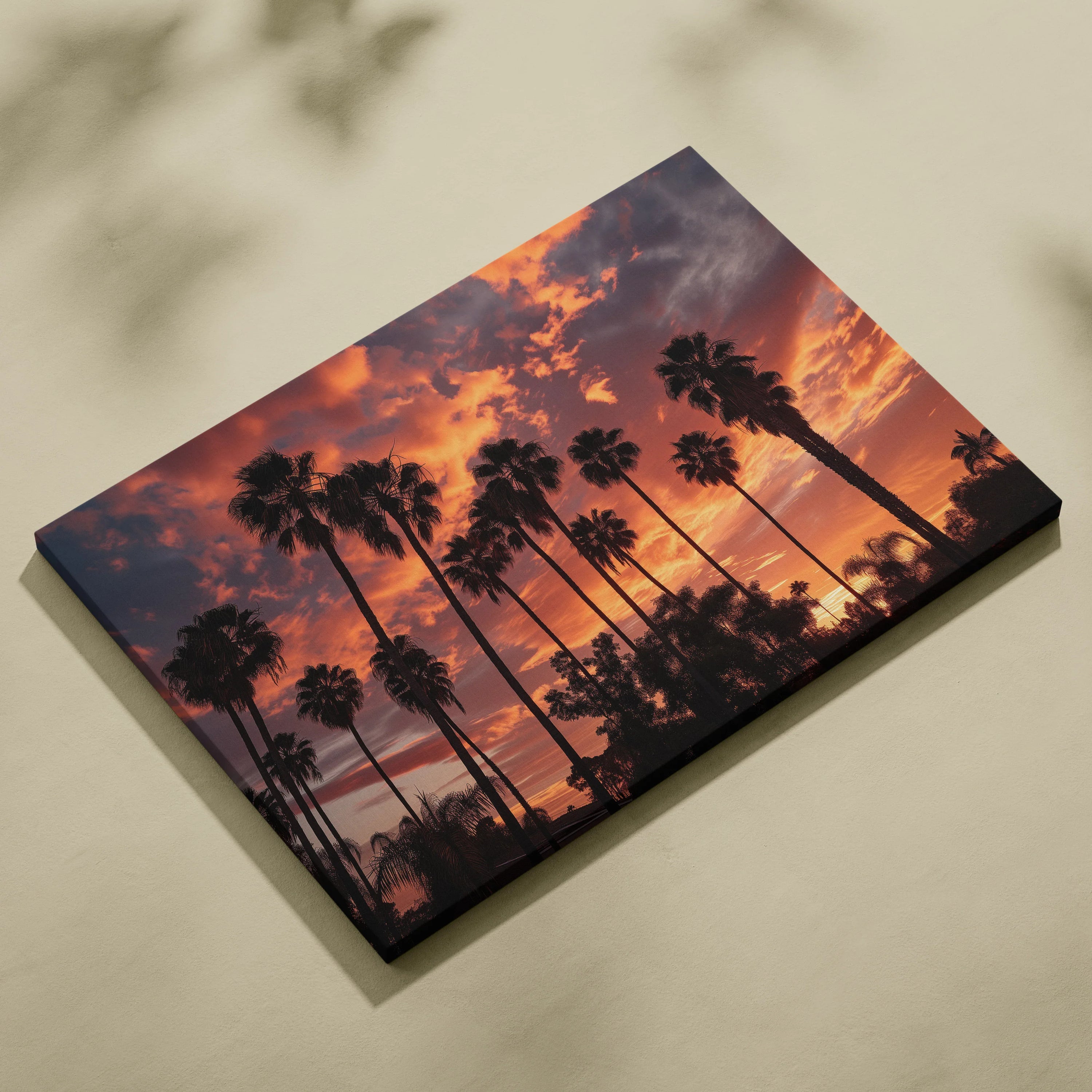 Canvas wall art featuring dark palm tree silhouettes against a vibrant orange and purple tropical sunset sky.