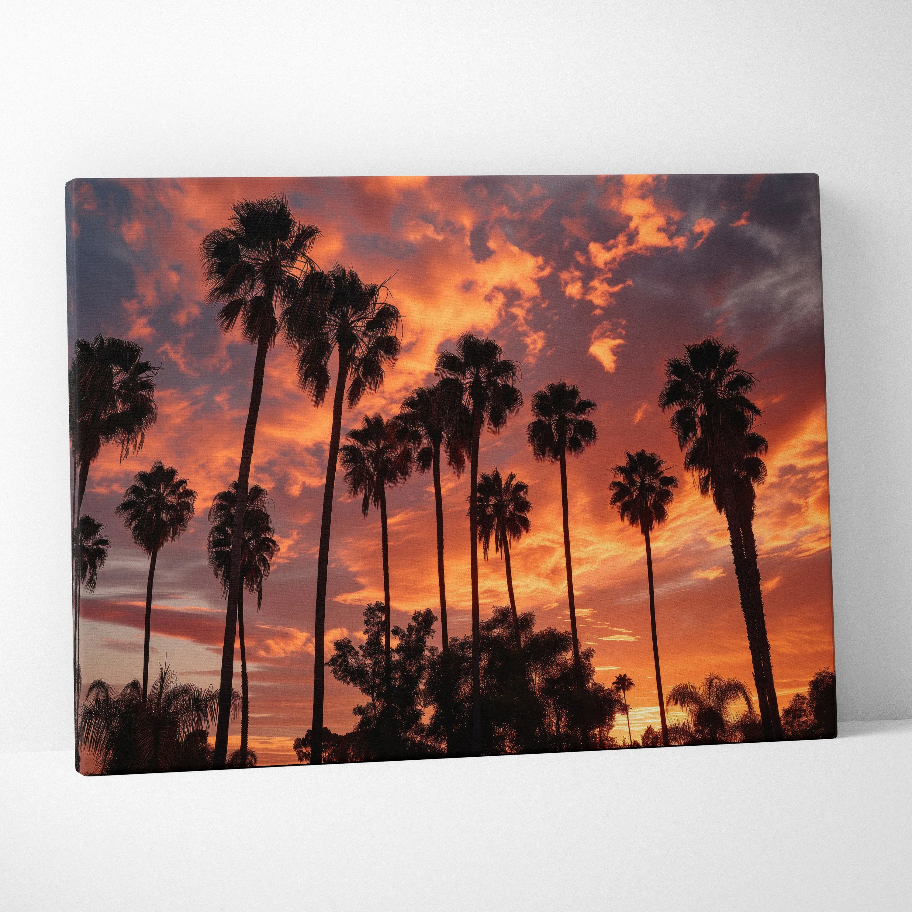 Canvas art featuring tall palm tree silhouettes against a vibrant tropical orange and purple sunset sky.