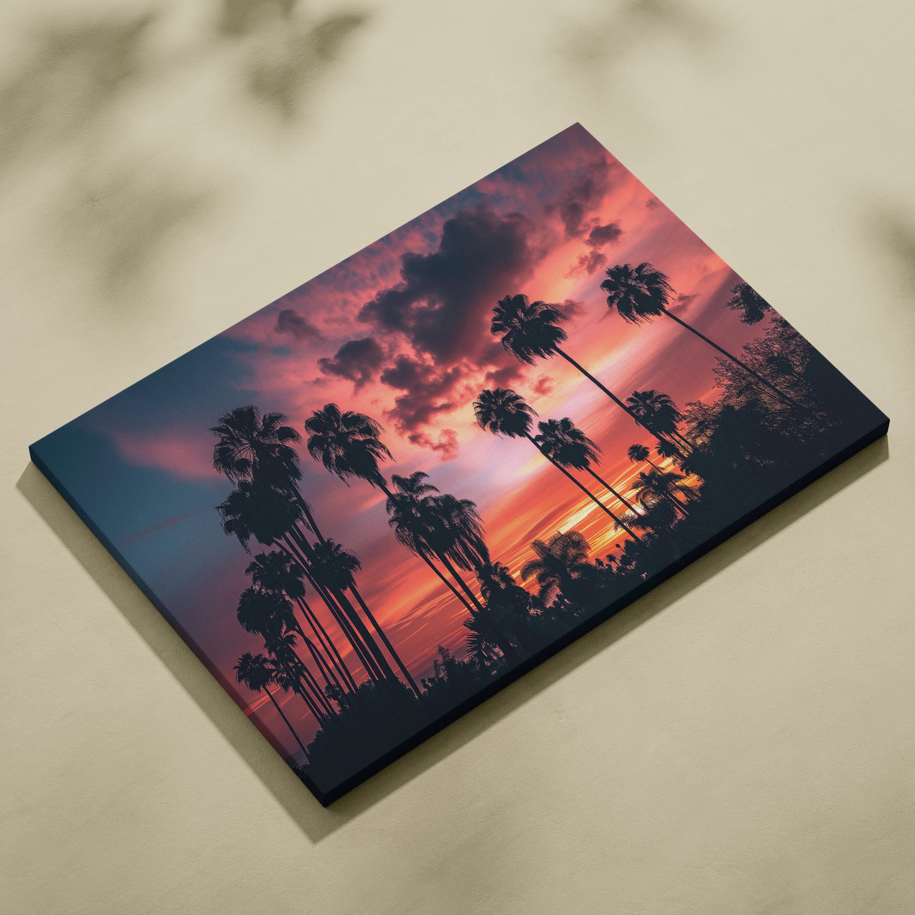 Canvas wall art featuring a digital tropical palm tree silhouette against a vibrant sunset sky with deep orange and purple.
