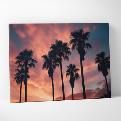 Canvas art depicting black palm tree silhouettes against a vibrant orange and purple sunset sky for tropical wall decor.