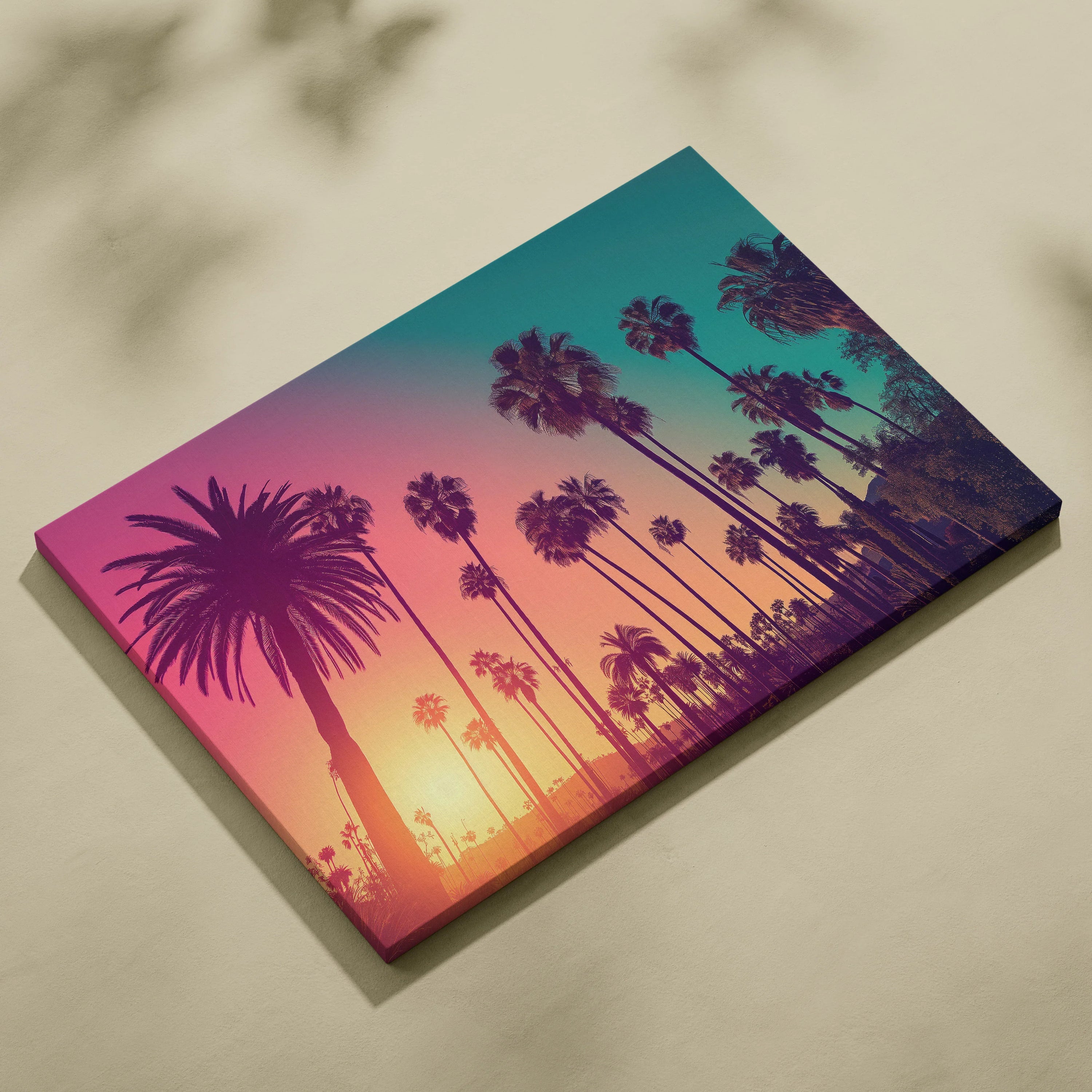Canvas wall art featuring a tropical sunset with black palm tree silhouettes against a gradient sky of pink, orange, and.