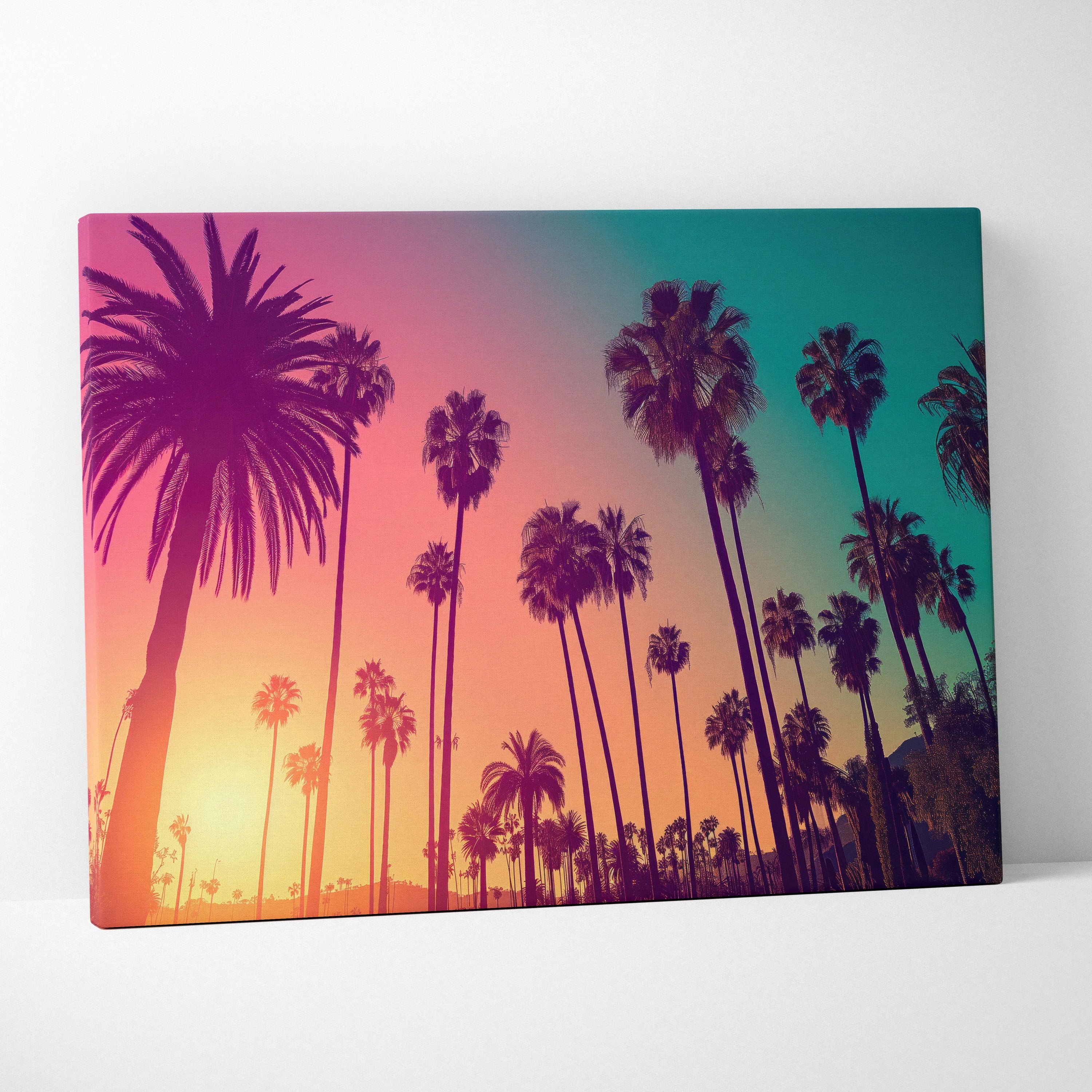 Canvas wall art featuring a tropical palm tree silhouette against a vibrant sunset gradient of pink, orange, and teal.
