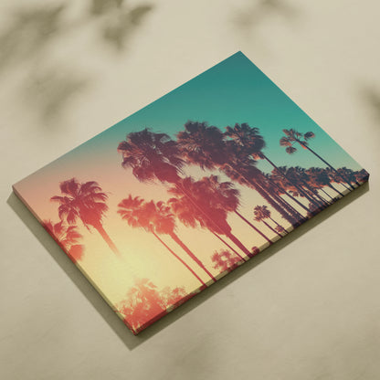 Canvas wall art featuring black tropical palm tree silhouettes against a warm amber and teal sunset background.