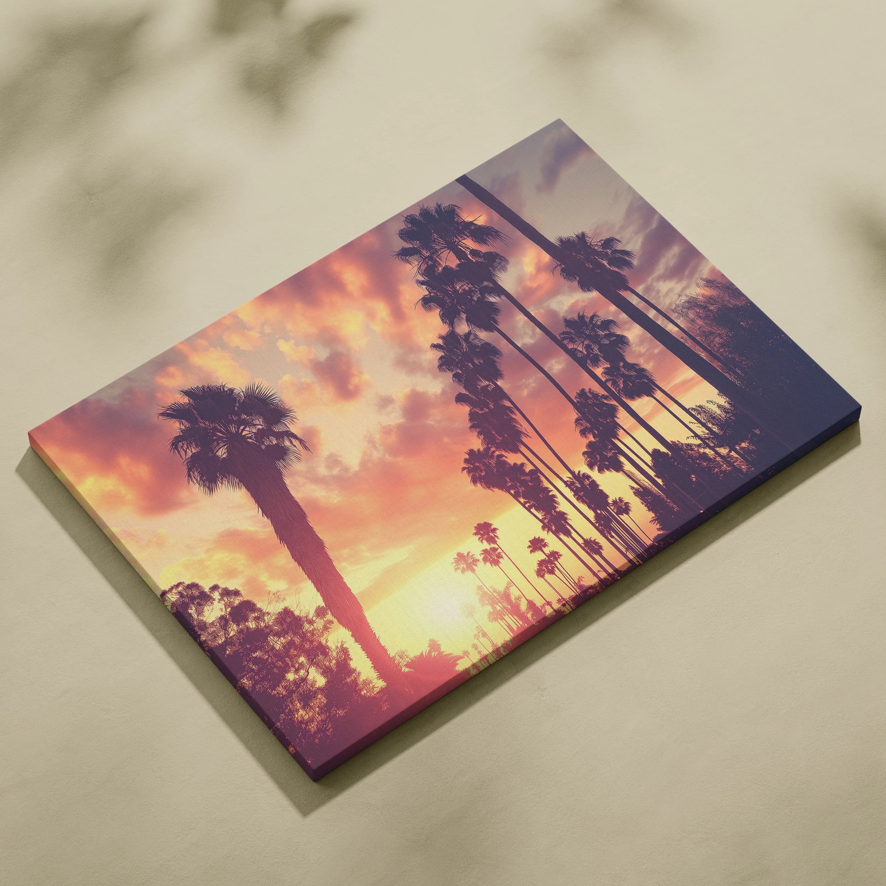 Canvas wall art featuring a tropical palm tree silhouette against a vibrant sunset sky.