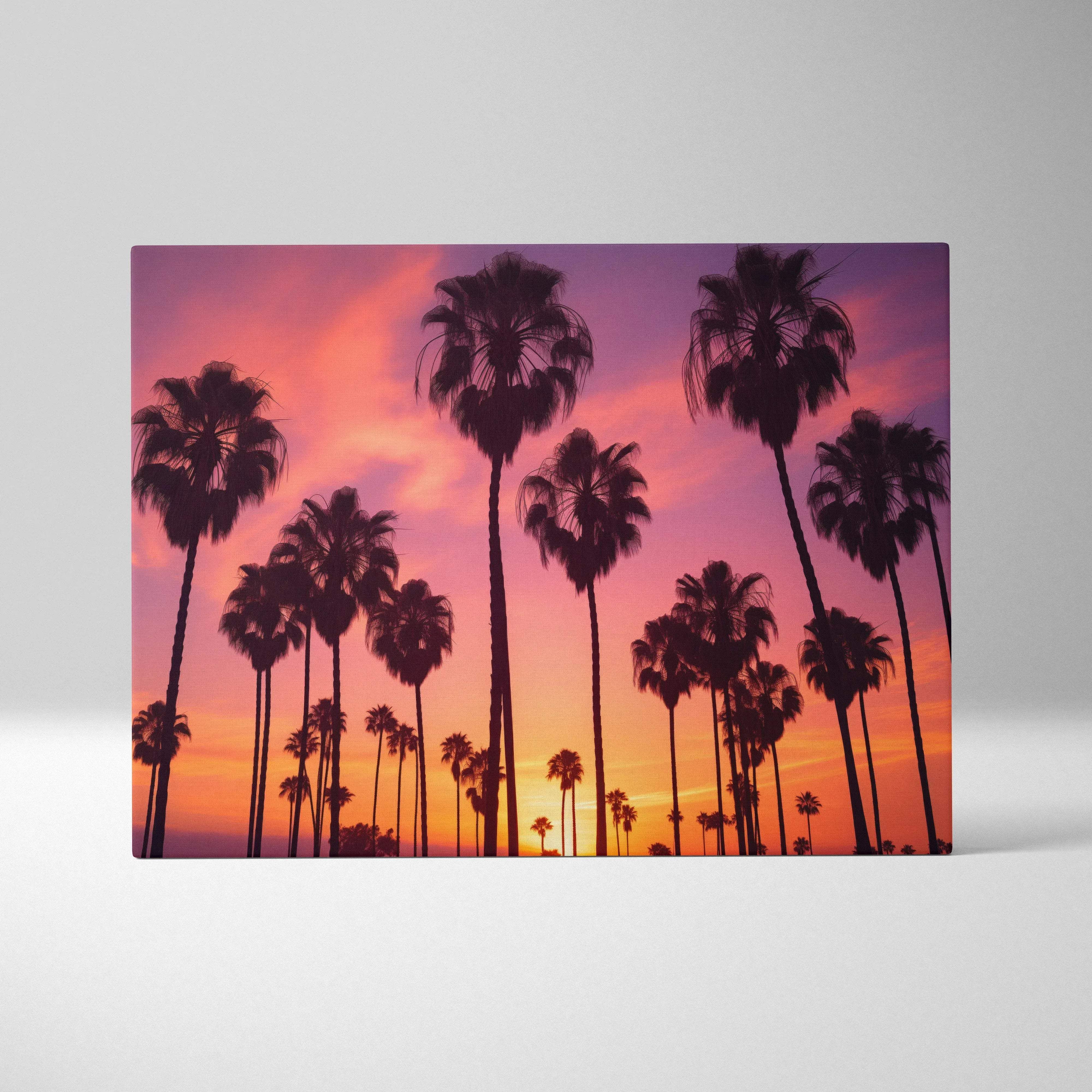 Rectangular canvas wall art featuring silhouetted palm trees against a vibrant tropical sunset sky in warm orange purple hues