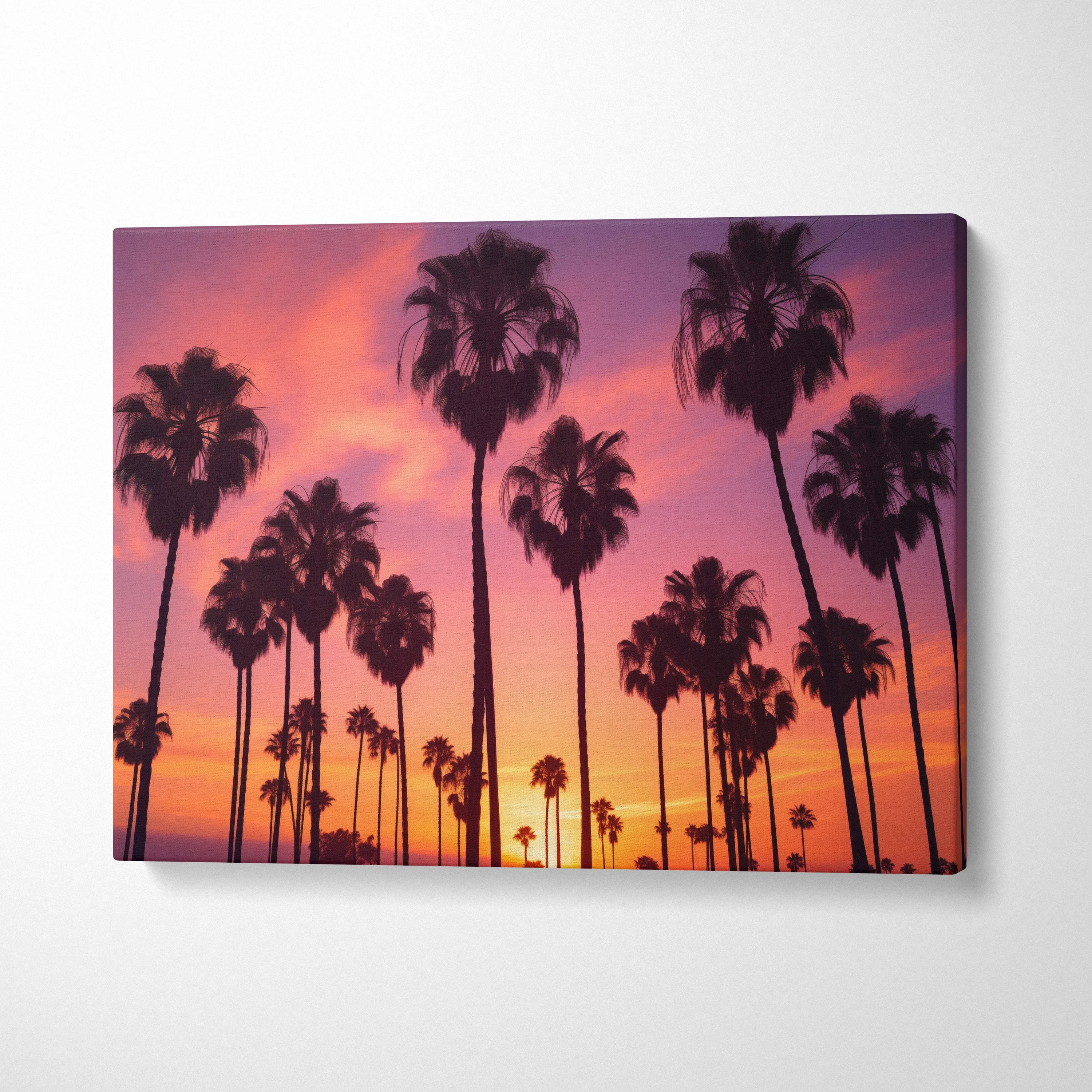 Tropical sunset palm trees silhouette canvas wall art with vibrant pink and orange sky decor.