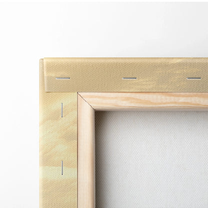 Close-up of wooden stretcher frame securing beige tropical sunset silhouette canvas wall art with visible staples.