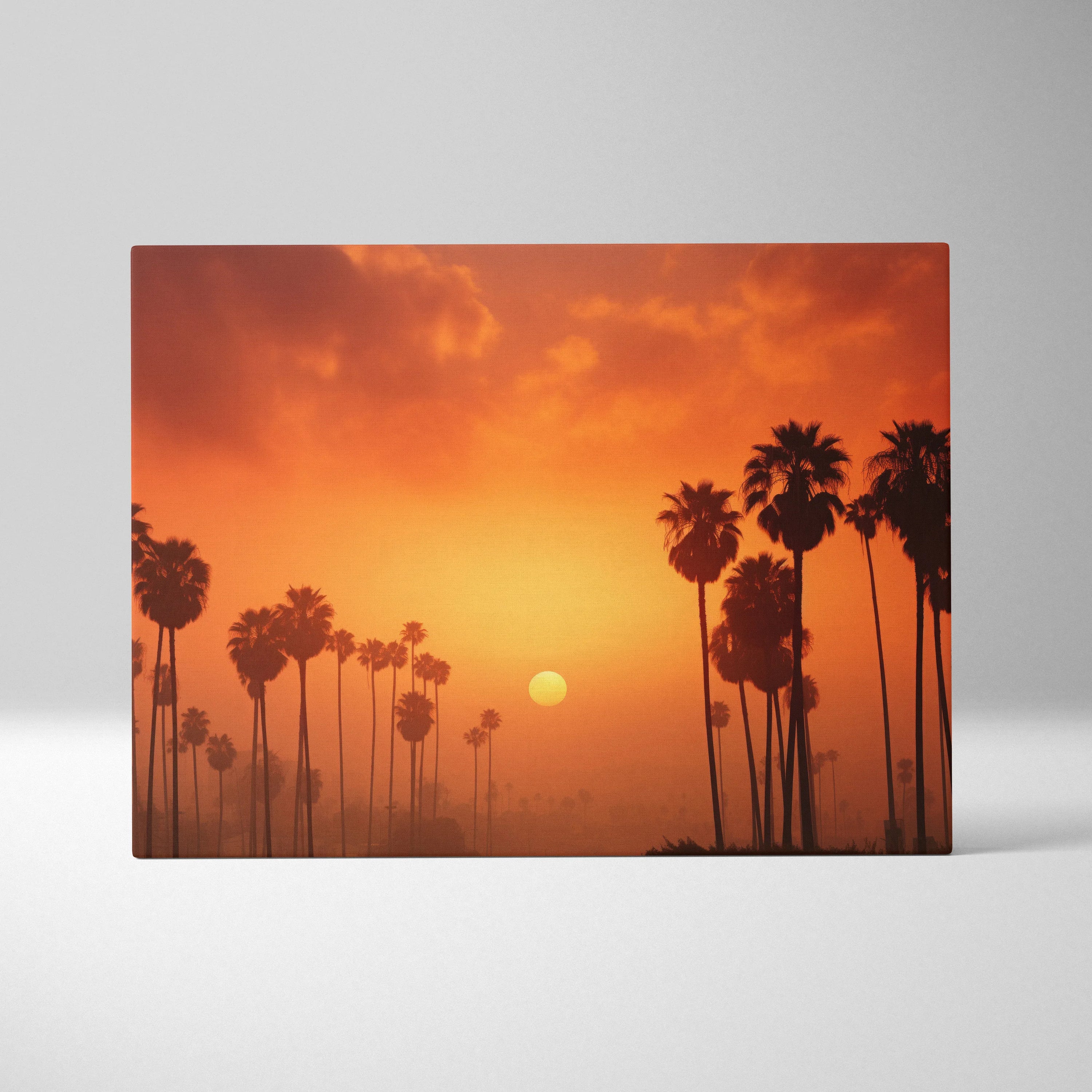 Canvas art featuring a tropical palm tree silhouette against a vibrant orange sunset sky wall art print.