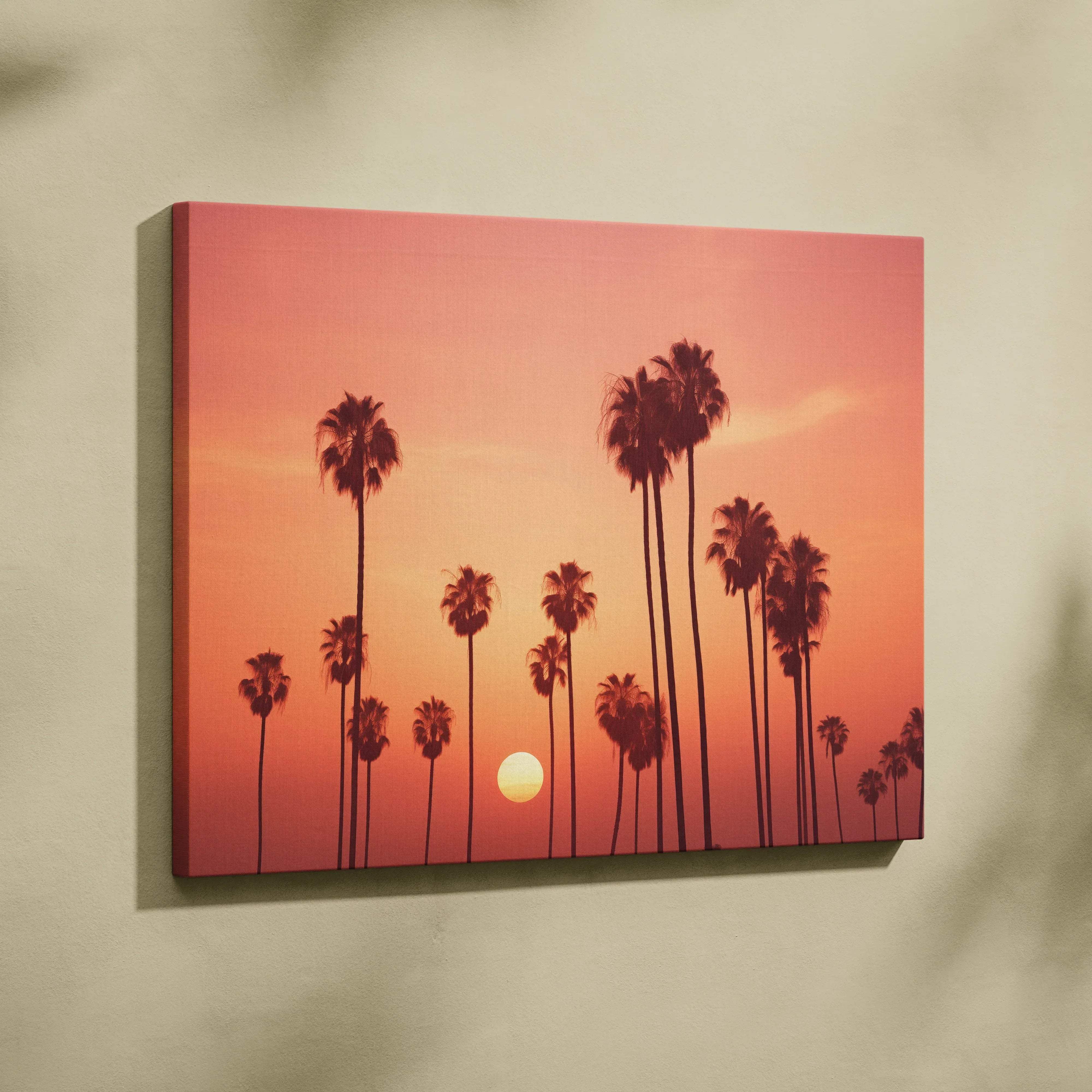 A vibrant canvas wall art featuring silhouetted palm trees against a warm orange and pink gradient sunset sky for coastal decor